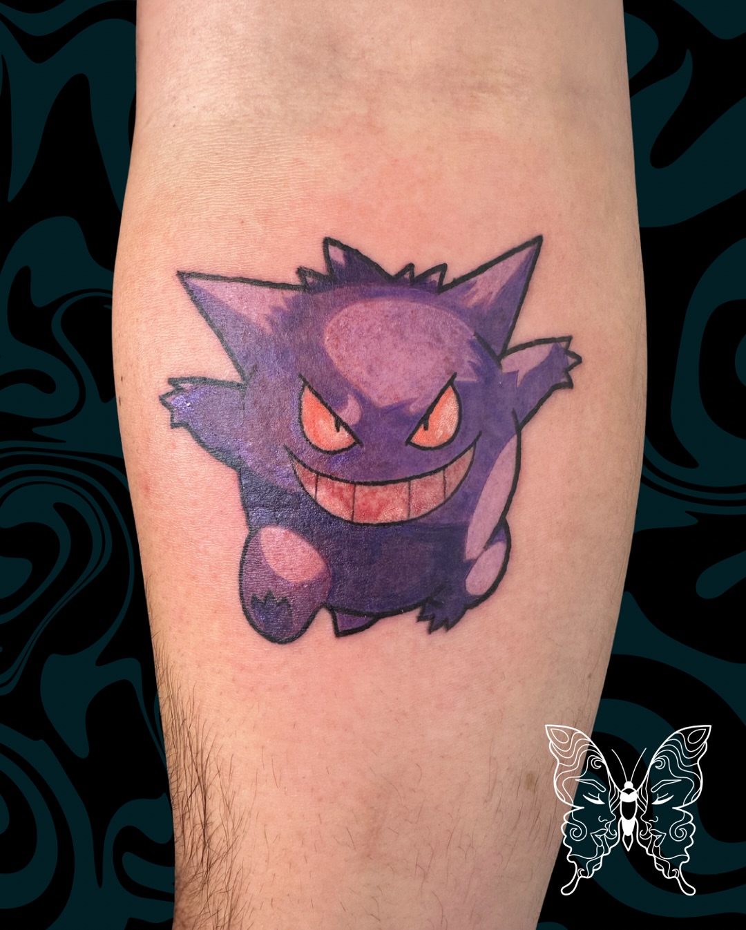 Gengar black and grey tattoo on the forearm by Nicci