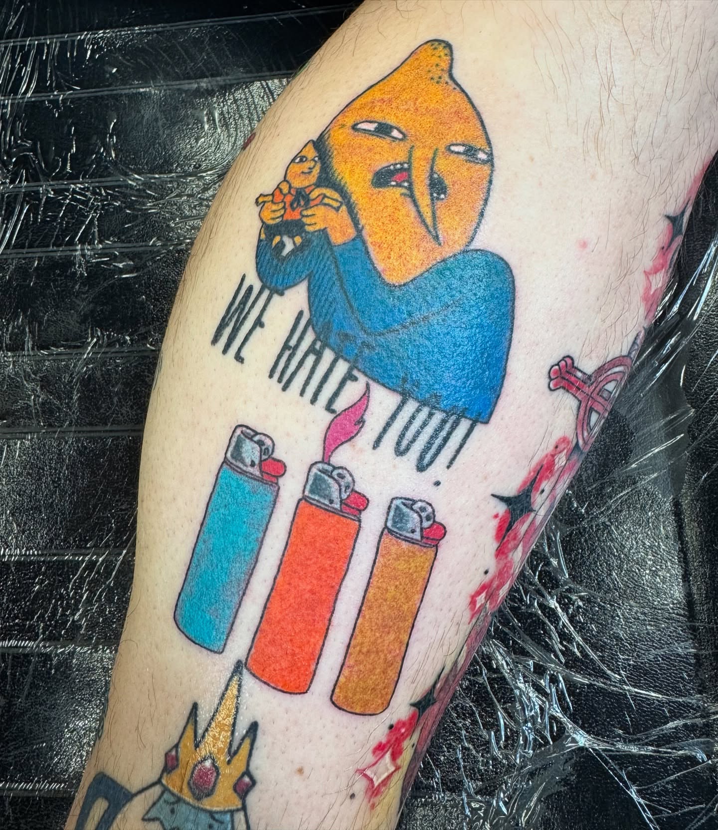 We hate you! illustrative tattoo on the forearm by Erin Moore
