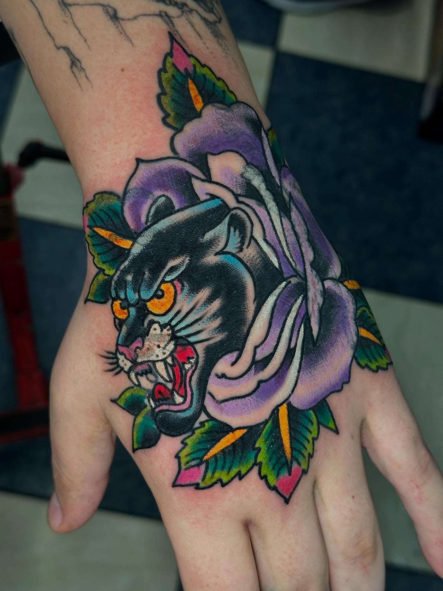 Panther and flower American traditional tattoo on the hand by David Steed, Dallas, Texas