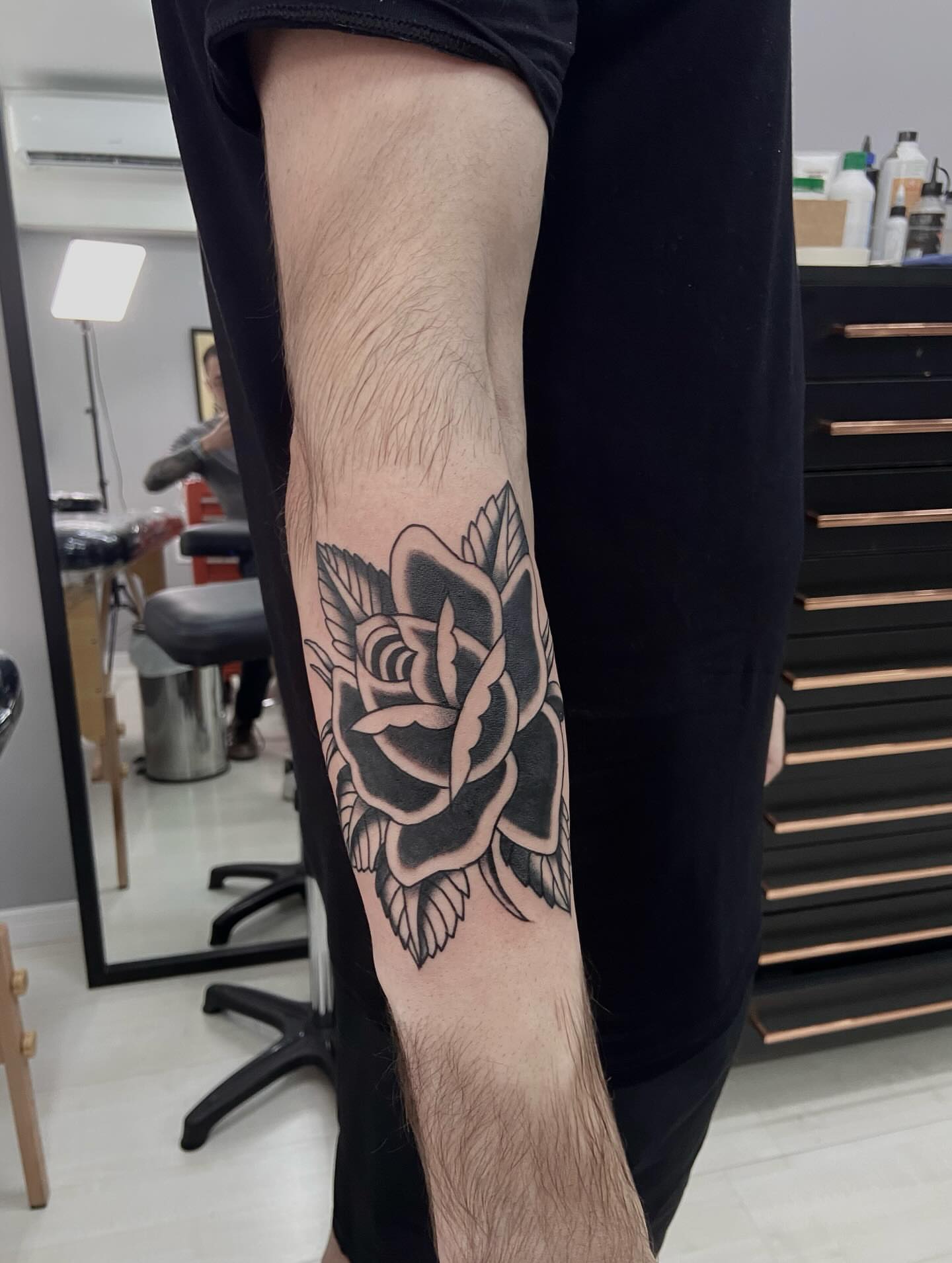 Rose black and grey tattoo on the forearm by Lucas Naganuma