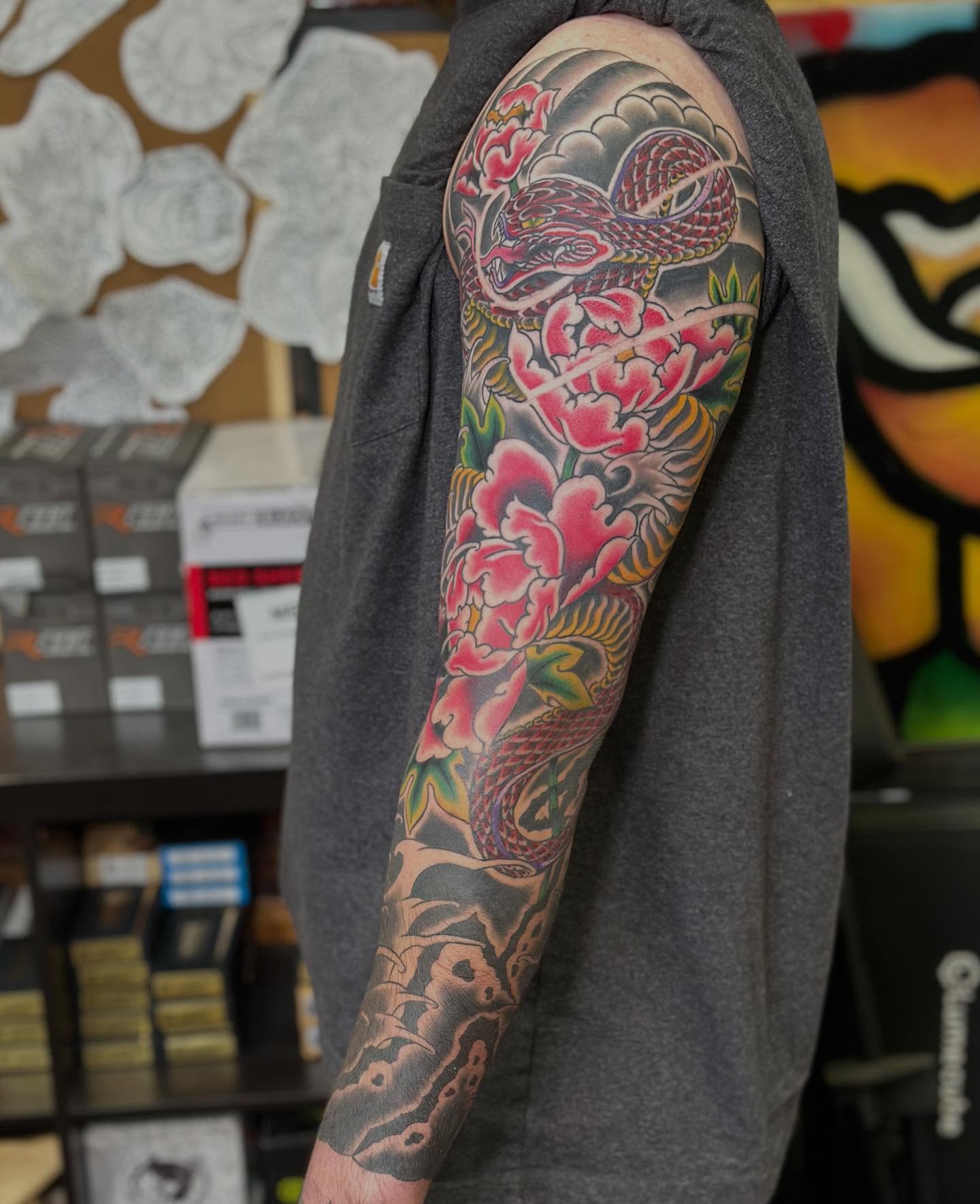 Snake and peony japanese irezumi tattoo on the upper arm by Wesley Lam