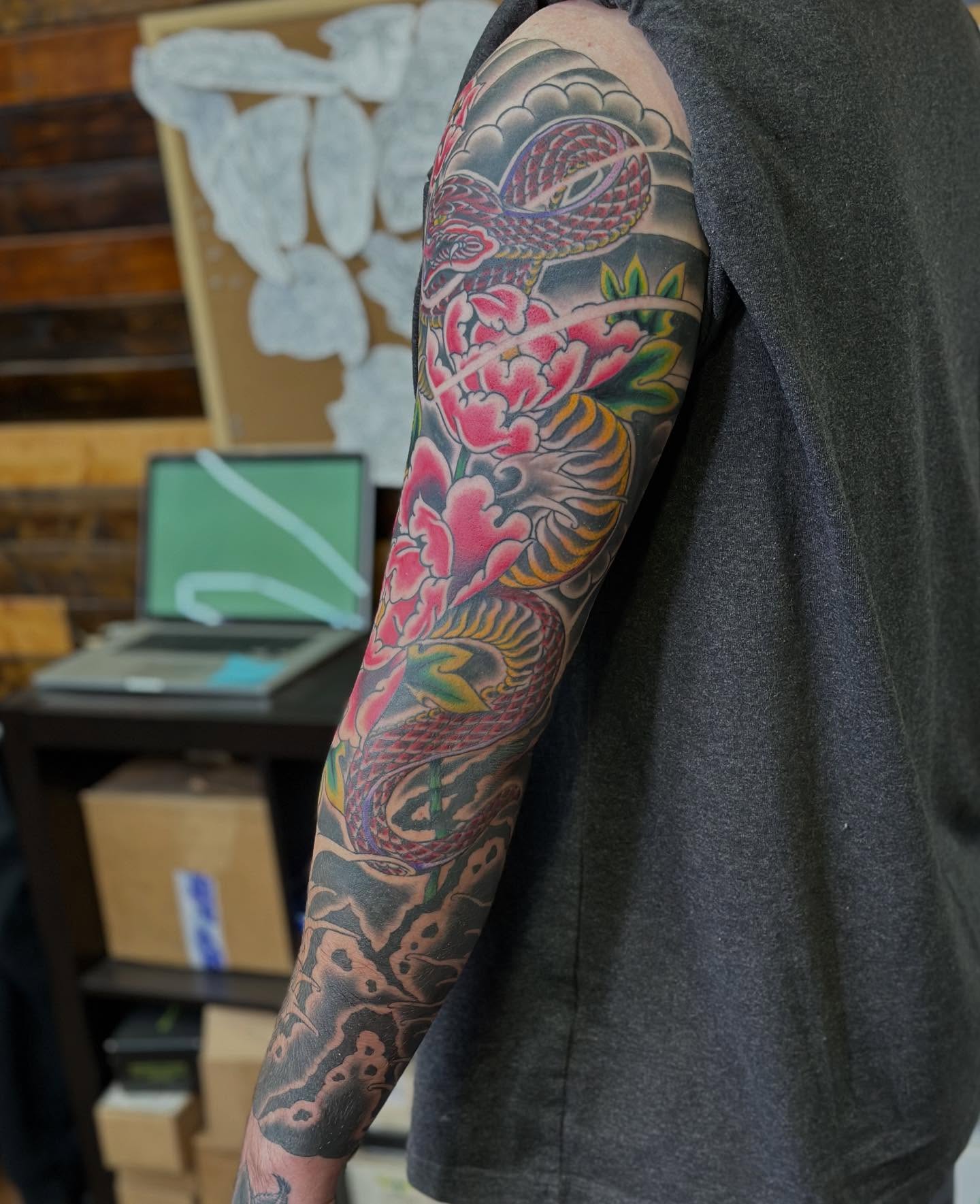 Snake and peony japanese irezumi tattoo on the upper arm by Wesley Lam