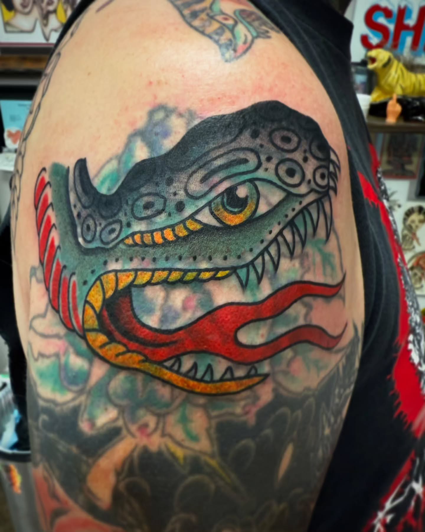 Dinosaur American traditional tattoo on the shoulder by Austin Liebst, Wichita, Kansas