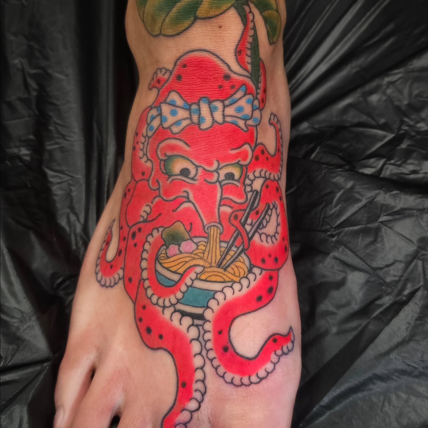 Octopus eating noodles new school tattoo on the foot by Avelourd Legaspi
