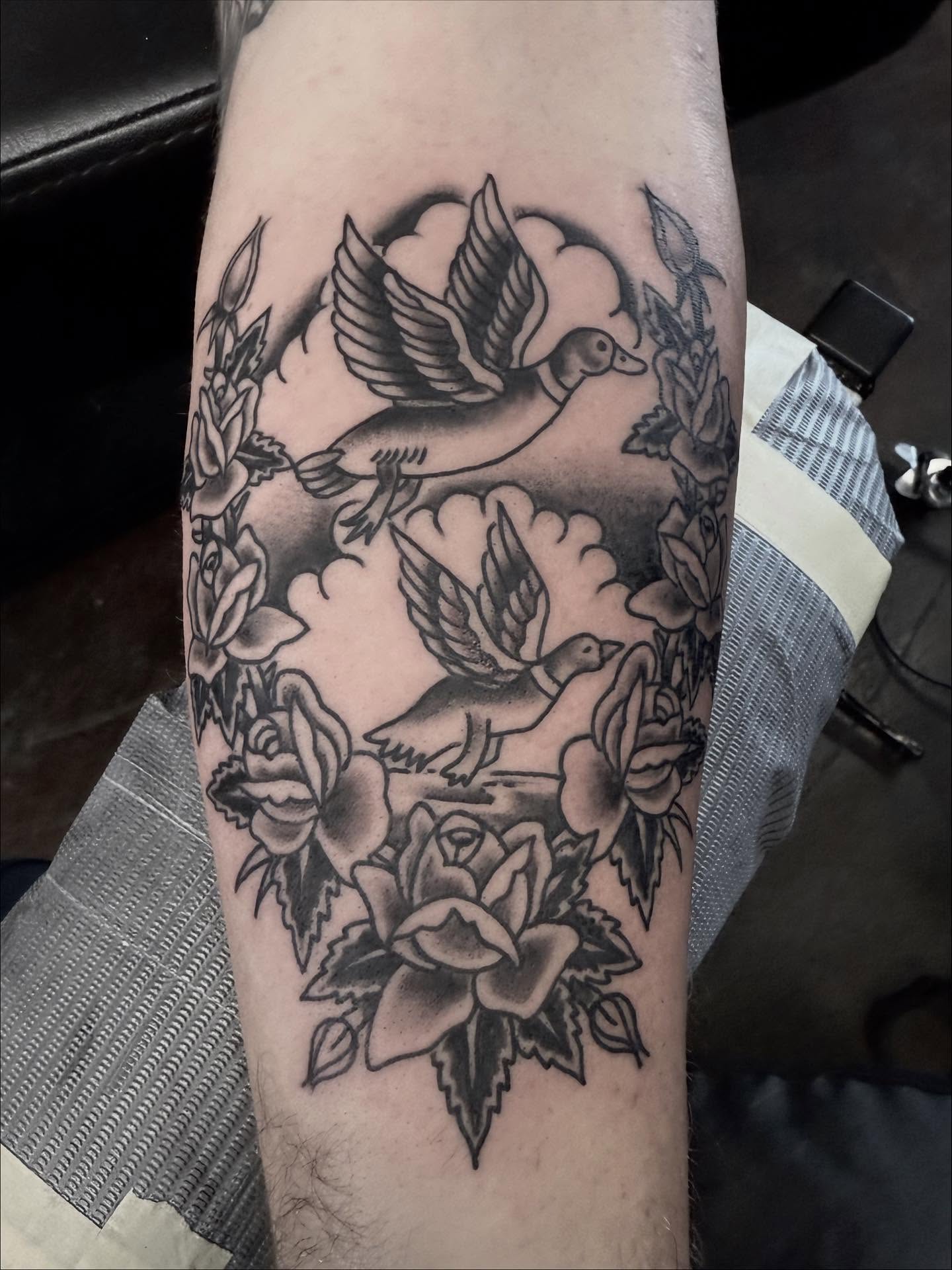 Ducks and roses American traditional tattoo on the forearm by Seth Walker