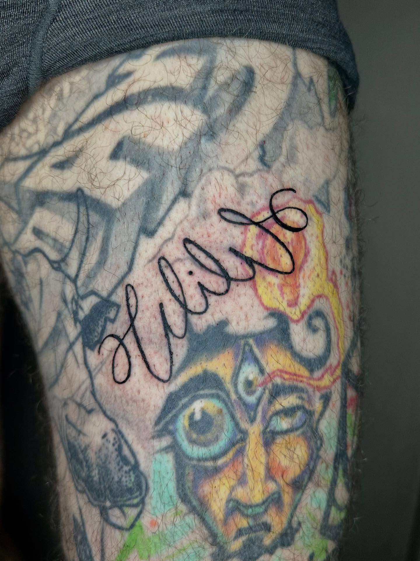 Face with colorful patterns dotwork tattoo on the forearm by Jadelin, San Francisco, California