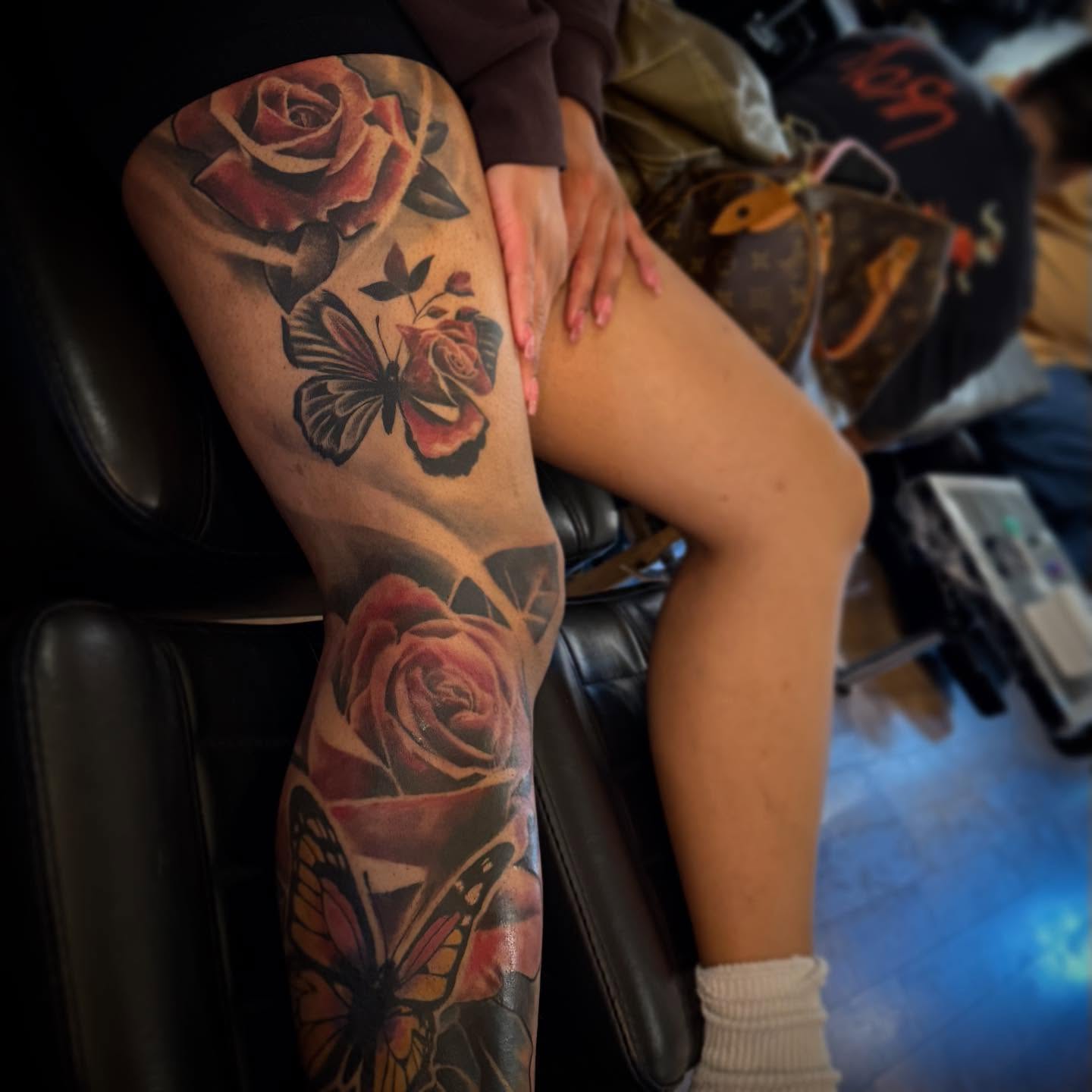 Roses and butterflies realism tattoo on the thigh by Erick Satchell II