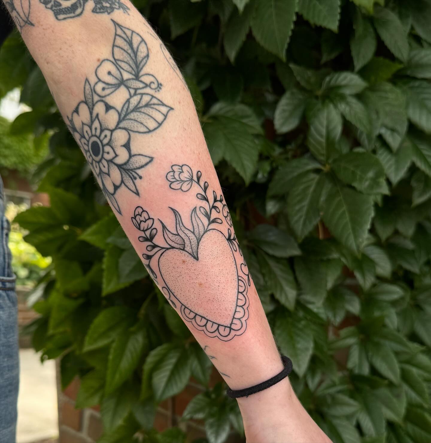 Heart with floral details black and grey tattoo on the forearm by ꧁꧁Hayley꧂꧂