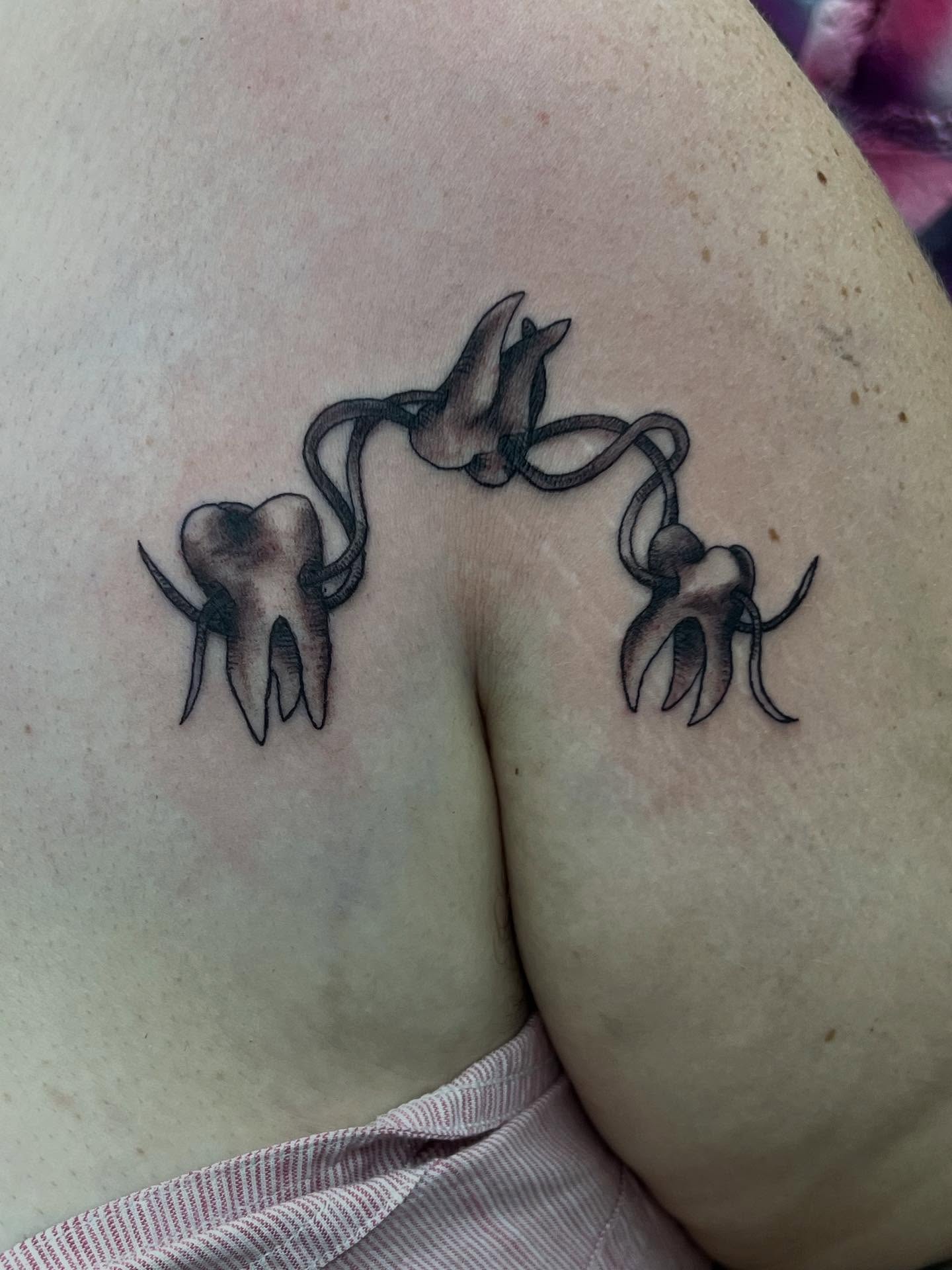 Teeth and roots black and grey tattoo on the shoulder by Sav