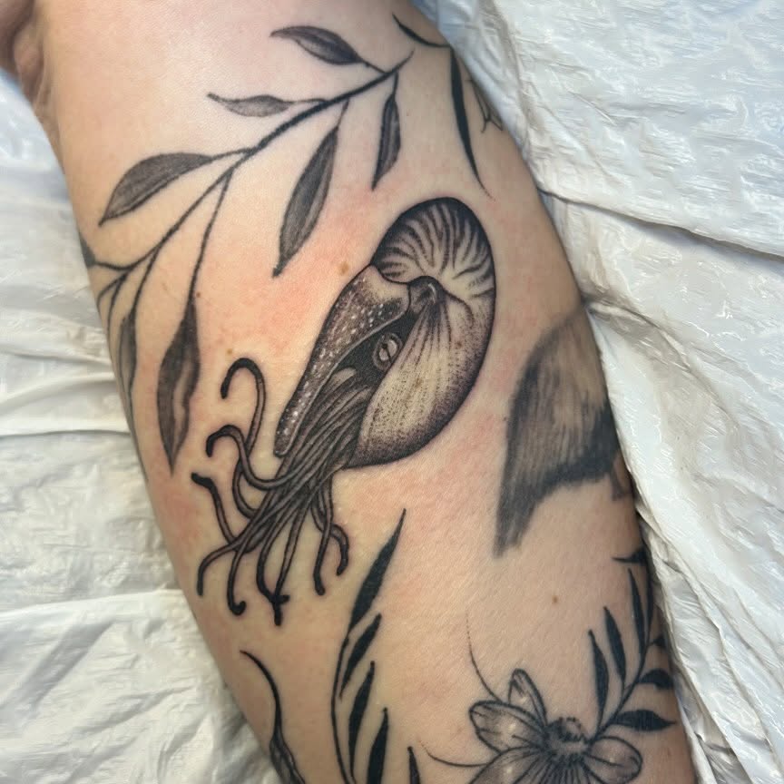 Squid and floral realism tattoo on the forearm by Kerri Colello Sittenauer
