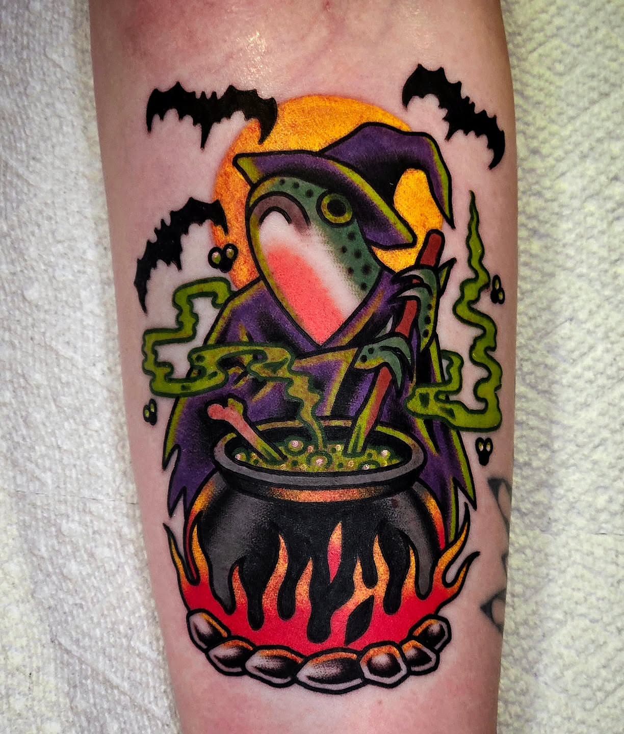 Witch brewing potion American traditional tattoo on the forearm by Mike Graske, Minneapolis, Minnesota