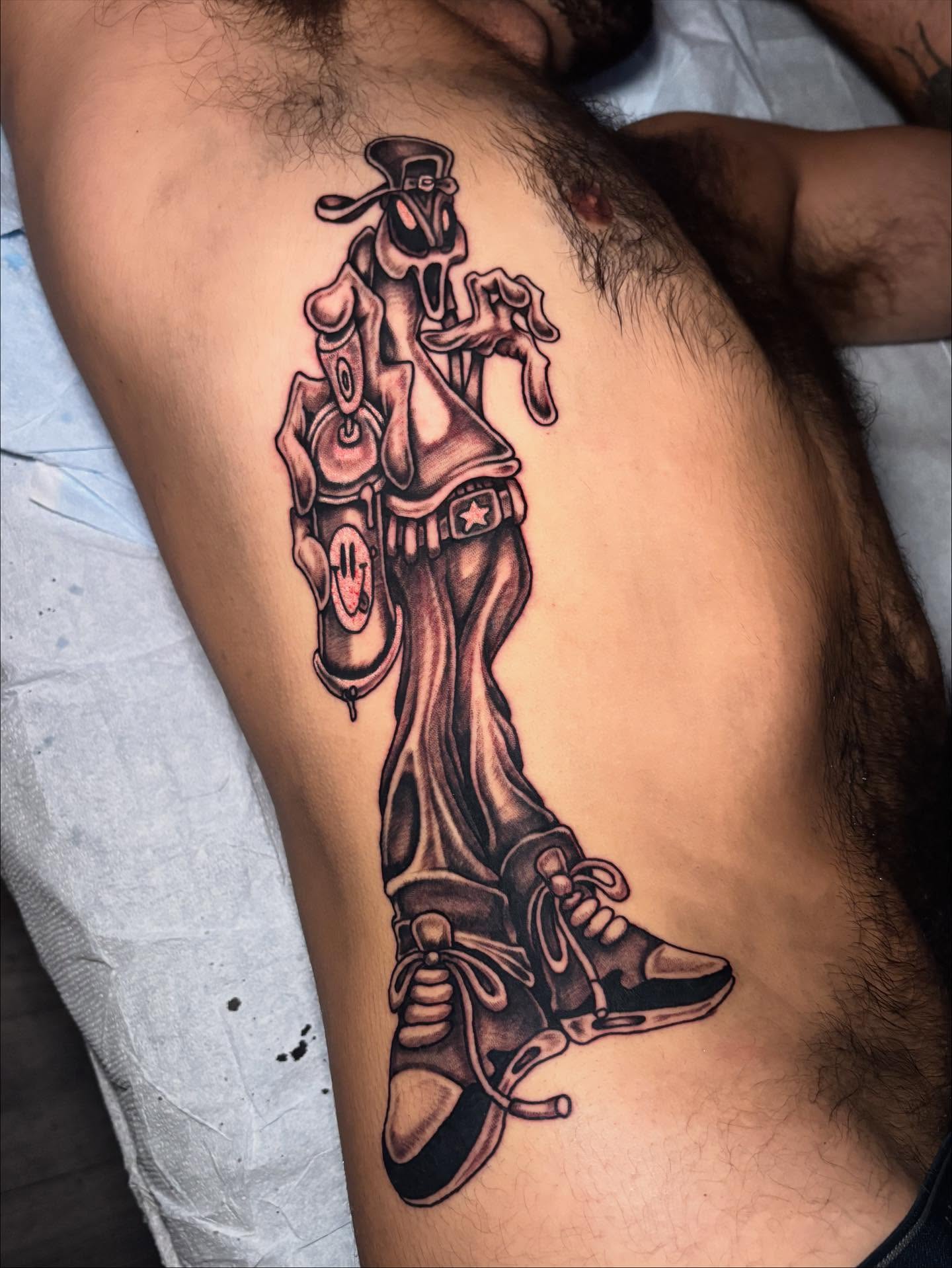 Skateboarder realism tattoo on the thigh by Brendan Smith