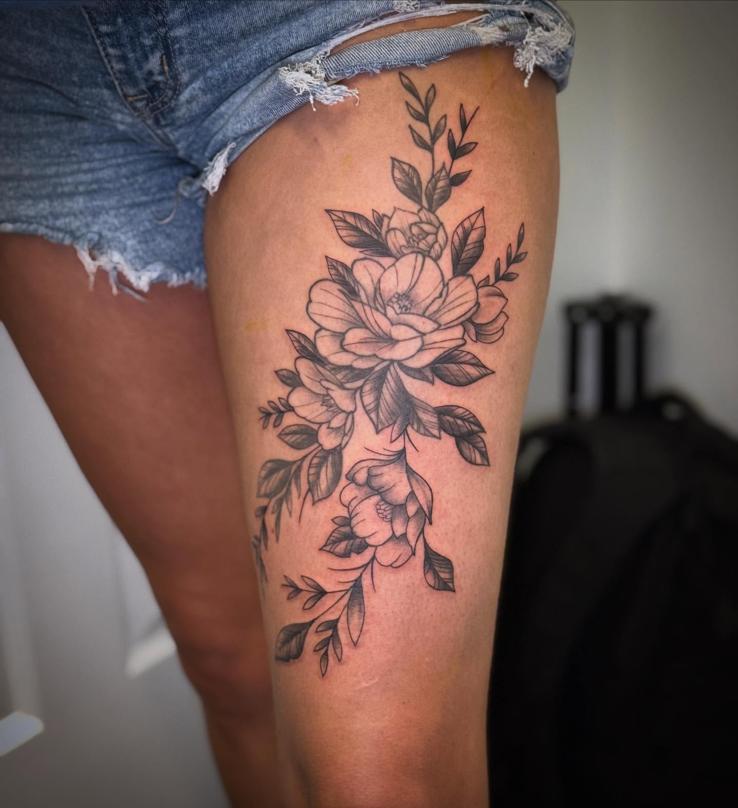 Floral bouquet black and grey tattoo on the thigh by Vega