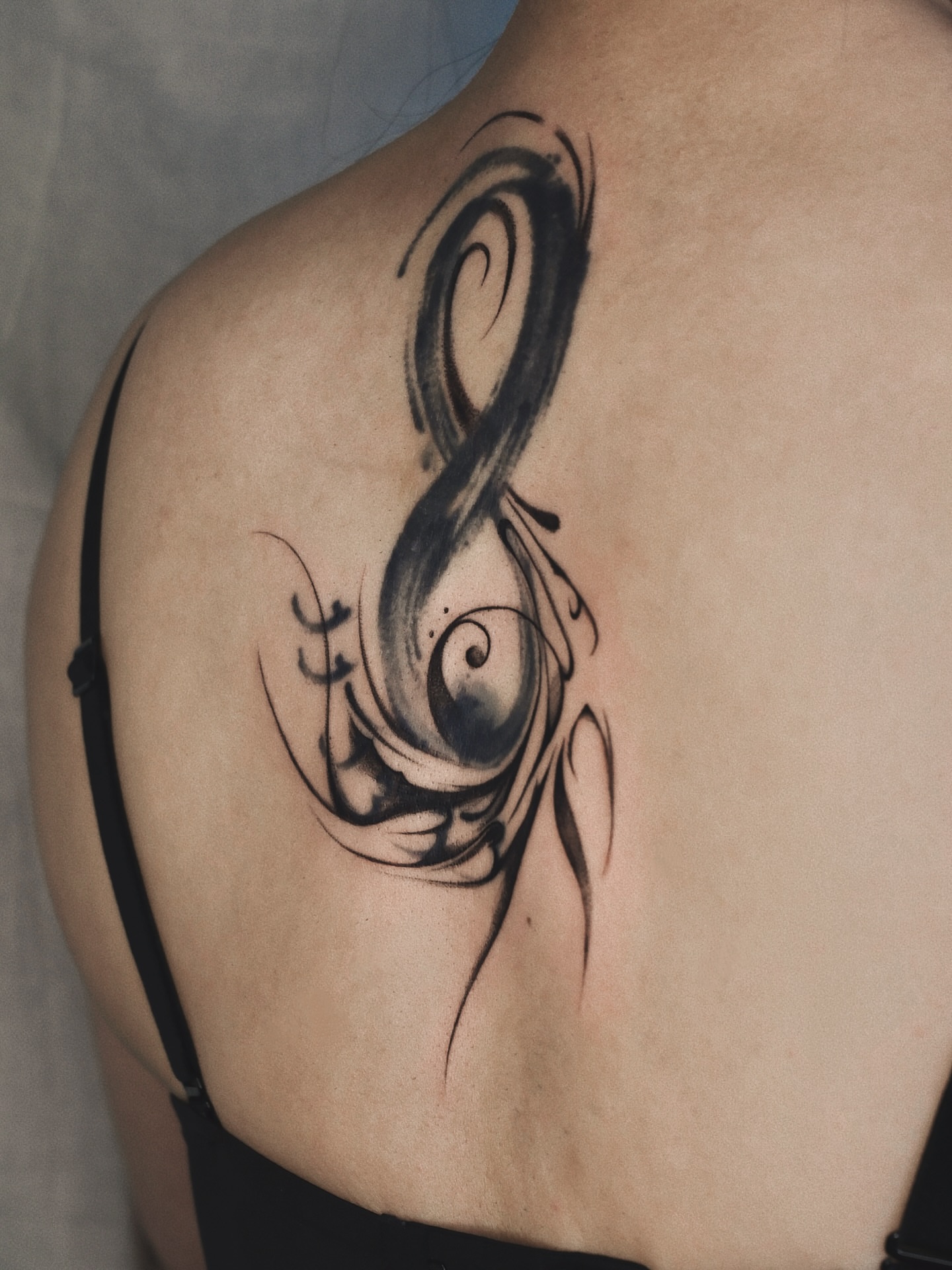 Treble clef black and grey tattoo on the shoulder by Max