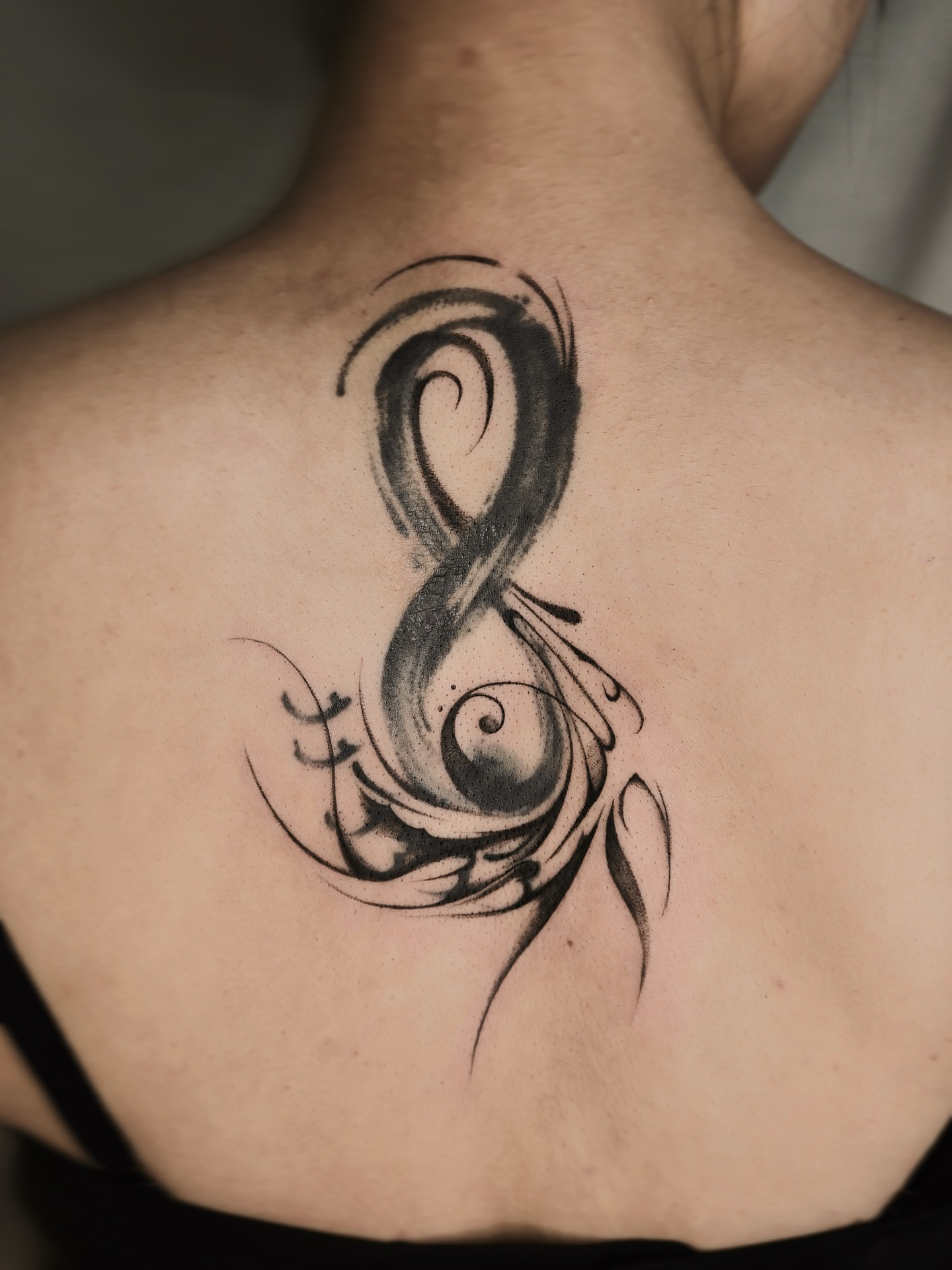 Infinity symbol black and grey tattoo on the back by Max