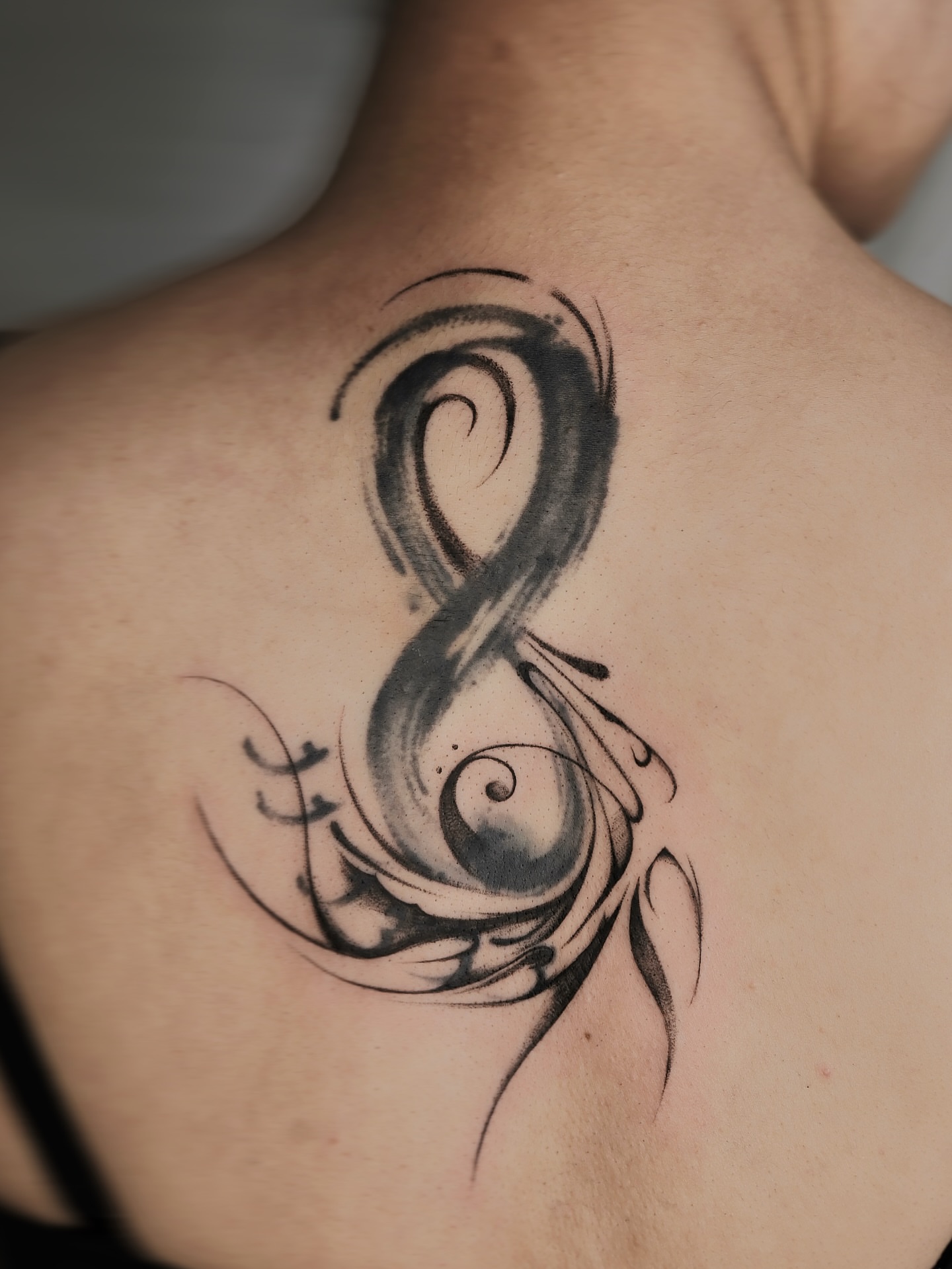 Swirl black and grey tattoo on the back by Max