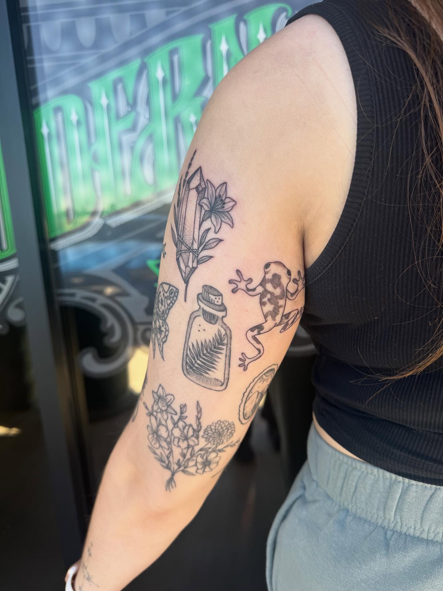 Botanical and animal motifs black and grey tattoo on the forearm by Jianna