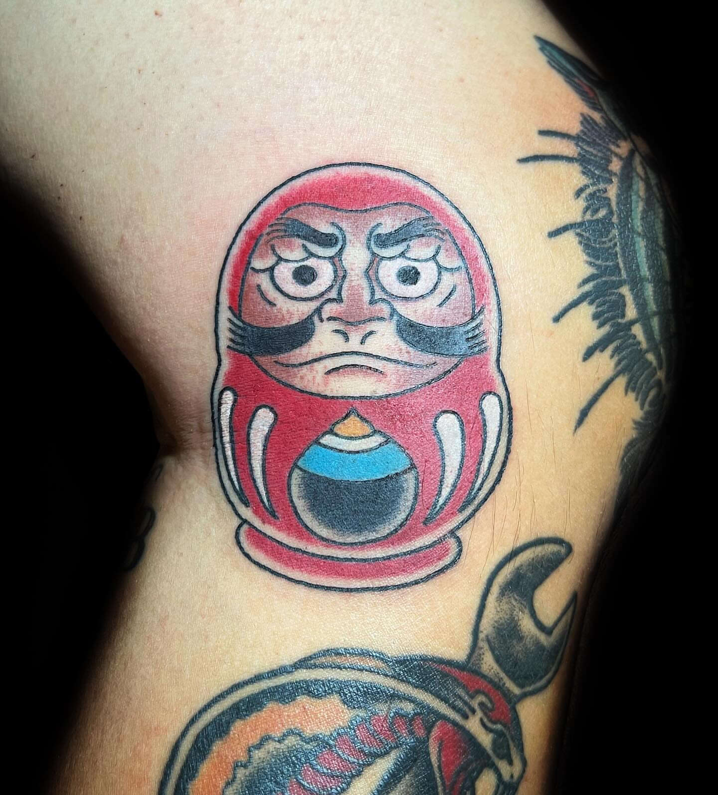 Daruma doll American traditional tattoo on the thigh by @sloanxkettering