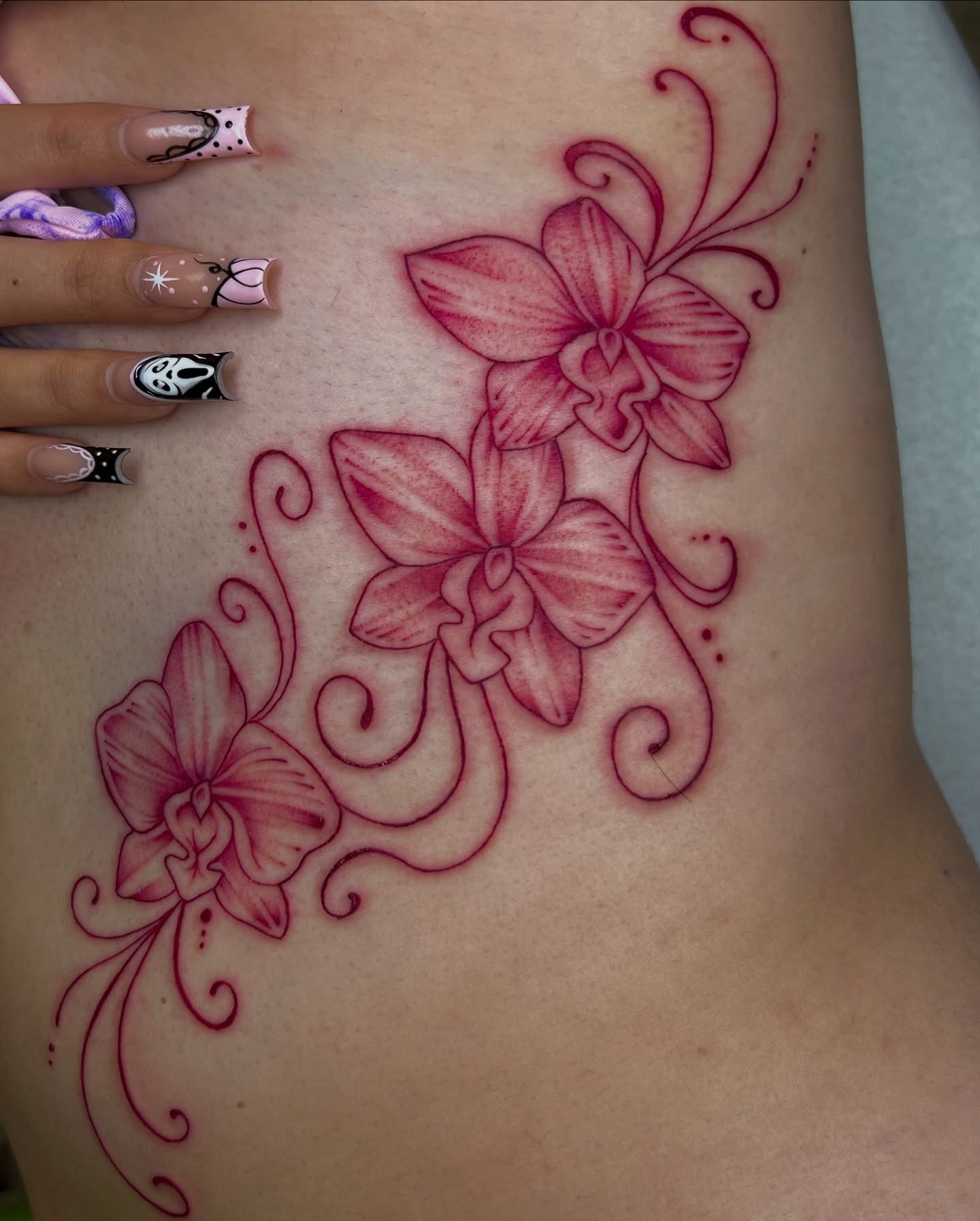 Orchids neo-traditional tattoo on the ribs by Nadia ★