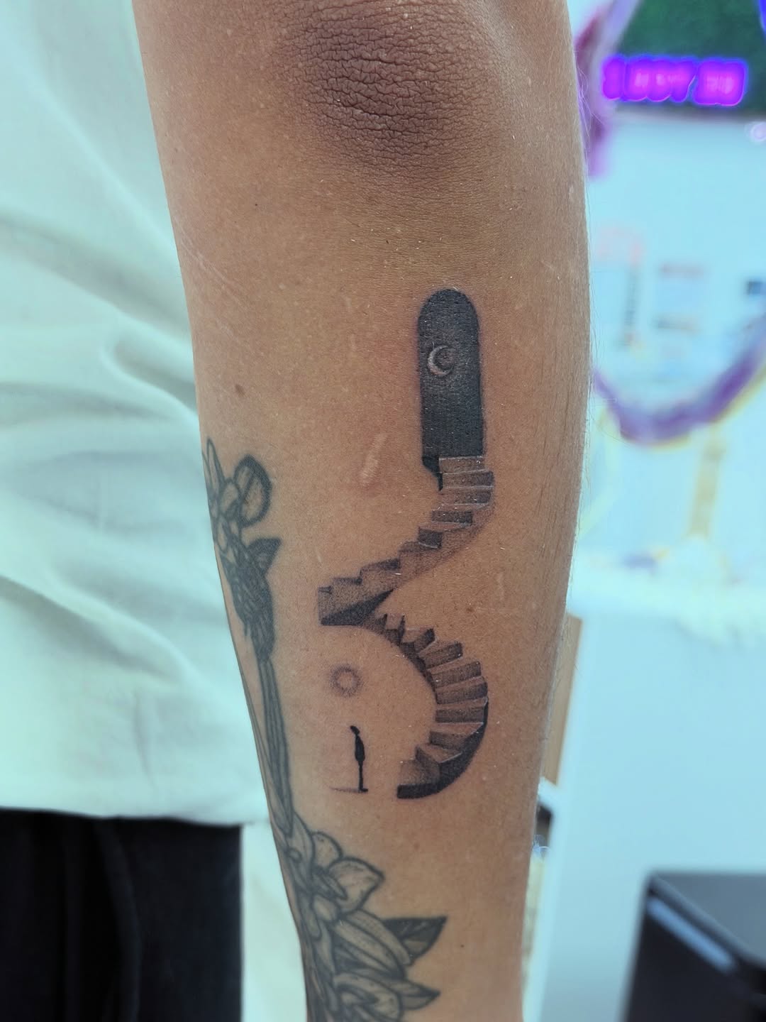Doorway with stairs and a figure surrealism tattoo on the forearm by Ink About Me - Amanda’s Fine Lines