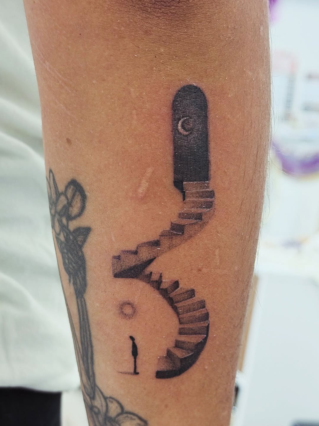 Doorway with stairs and a person sketch tattoo on the forearm by Ink About Me - Amanda’s Fine Lines