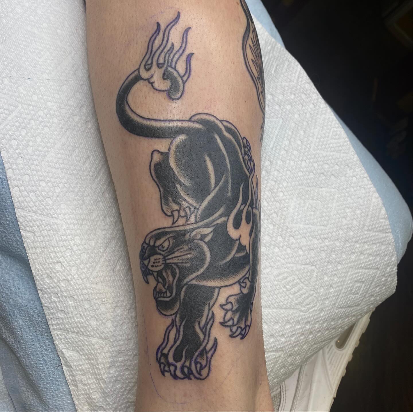 Panther with trident American traditional tattoo on the forearm by Thomas Cook