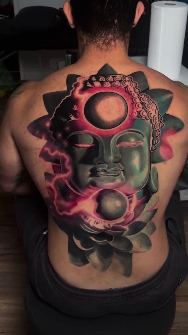 Buddha face with celestial elements realism tattoo by Bobby Cupparo