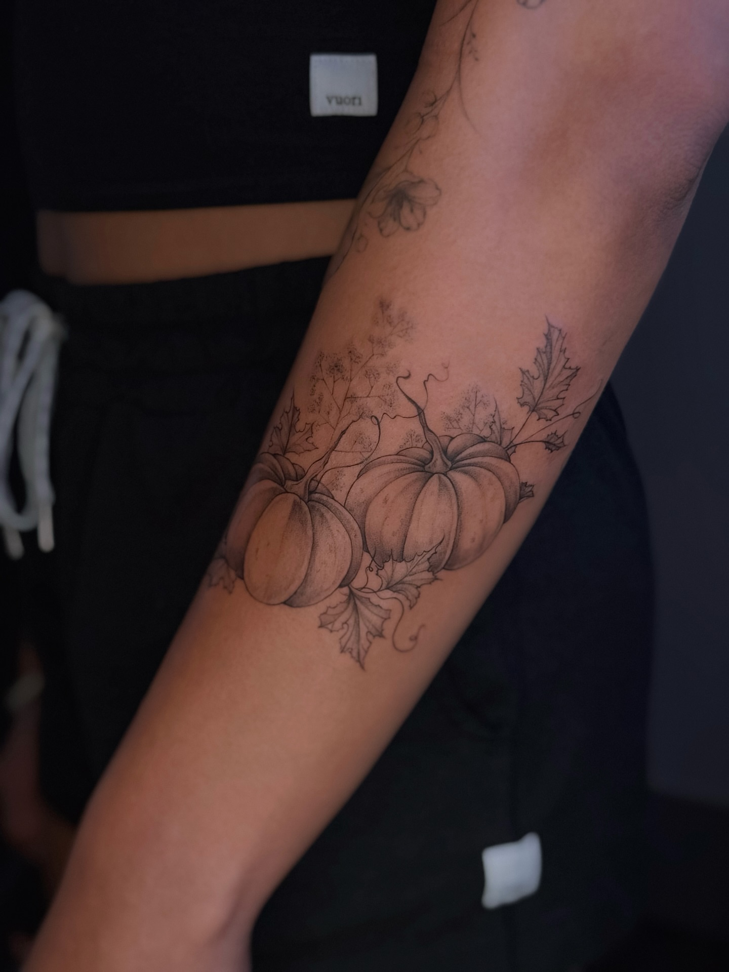 Pumpkins black and grey tattoo on the forearm by Daria