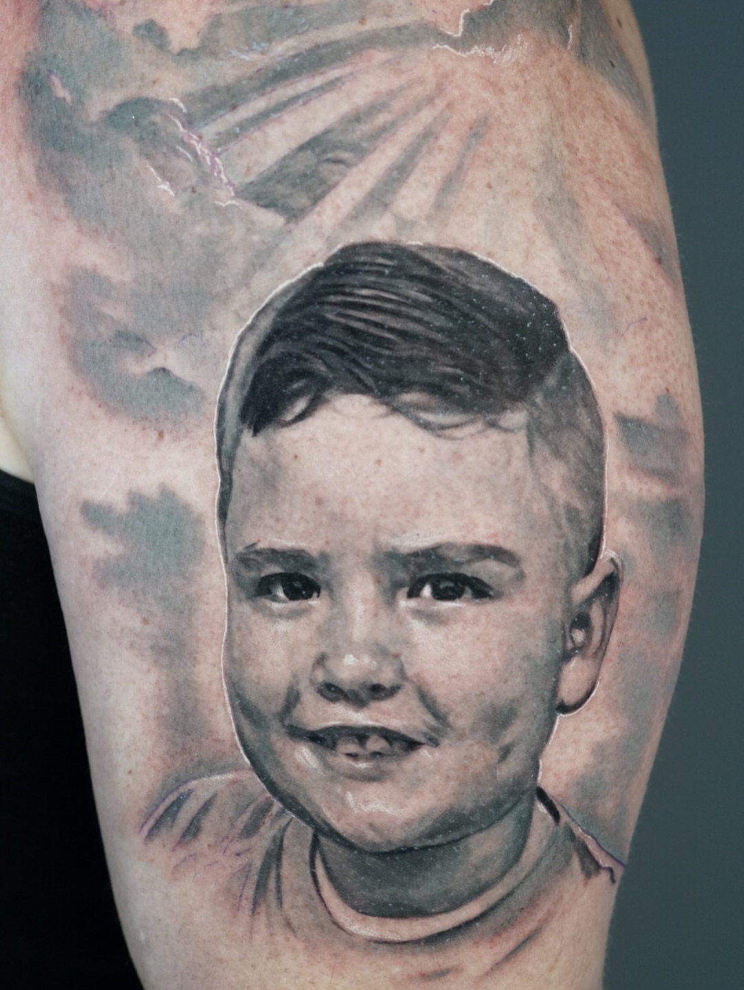 Child portrait realism tattoo on the forearm by Jose Carlos
