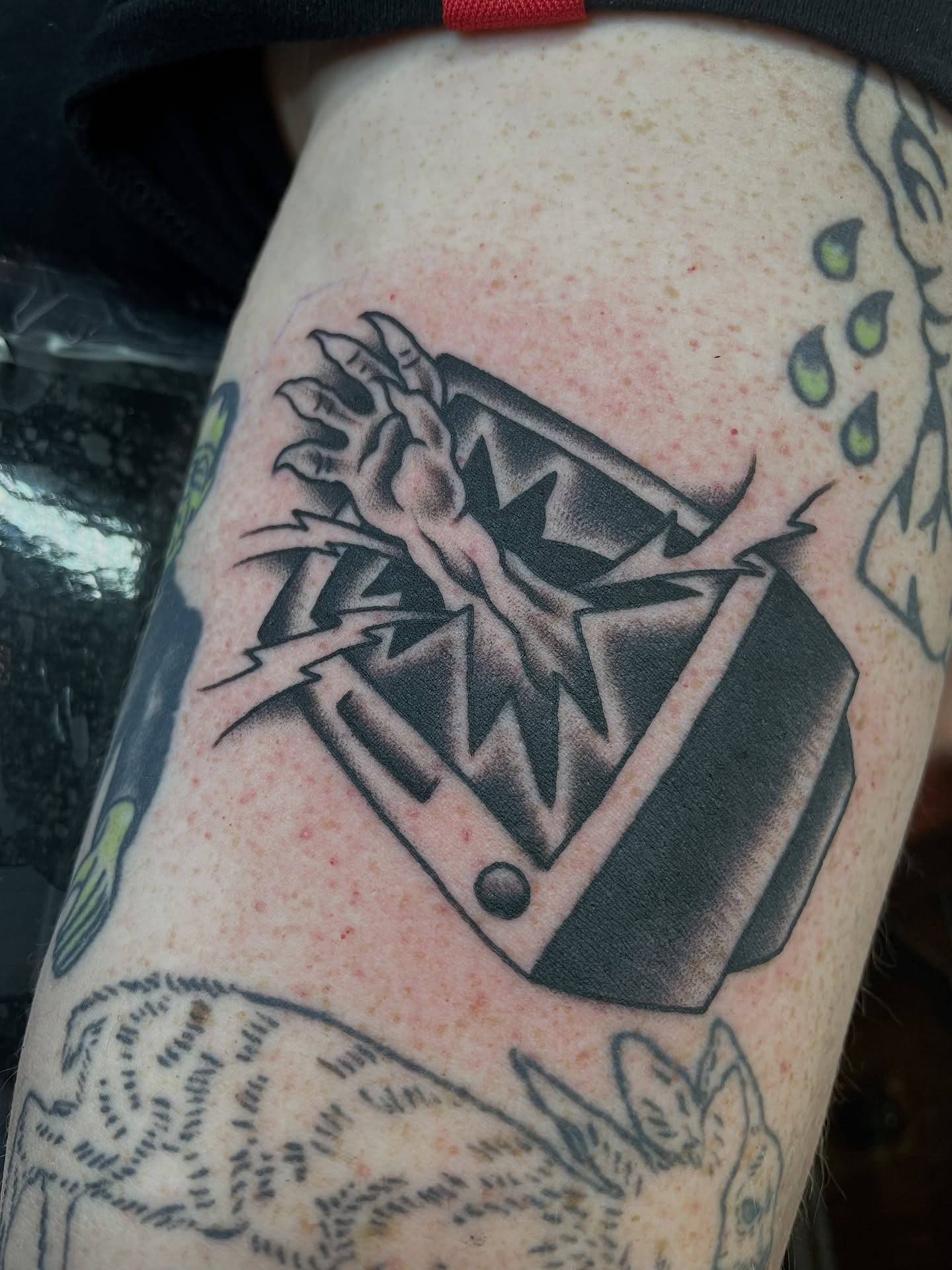 Box with claw black and grey tattoo on the thigh by Tom Taylor, Philadelphia, Pennsylvania