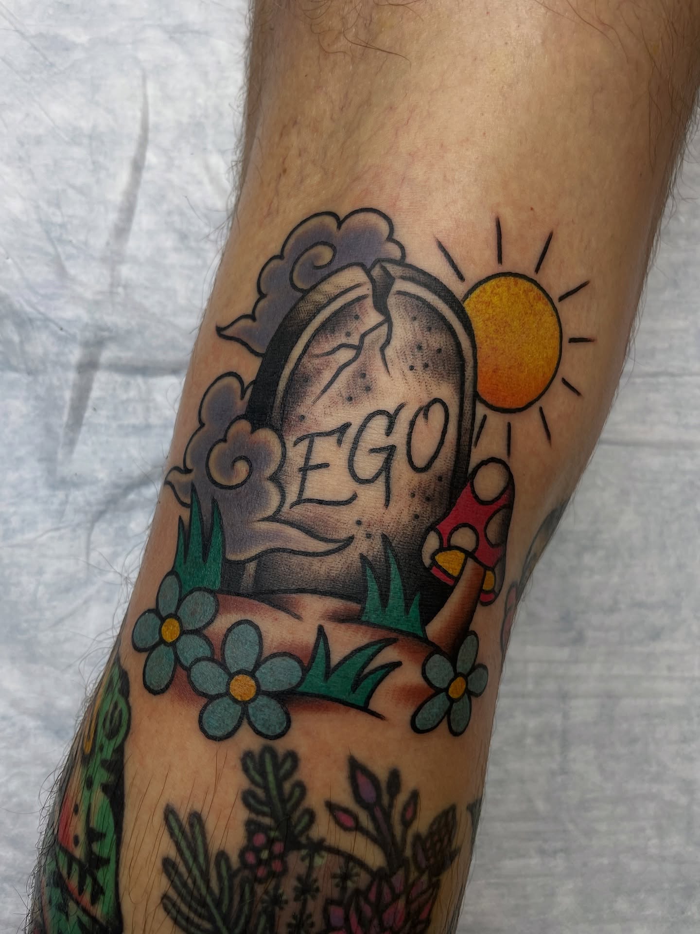 Grave with 'ego' inscription American traditional tattoo on the forearm by Tom Taylor, Philadelphia, Pennsylvania