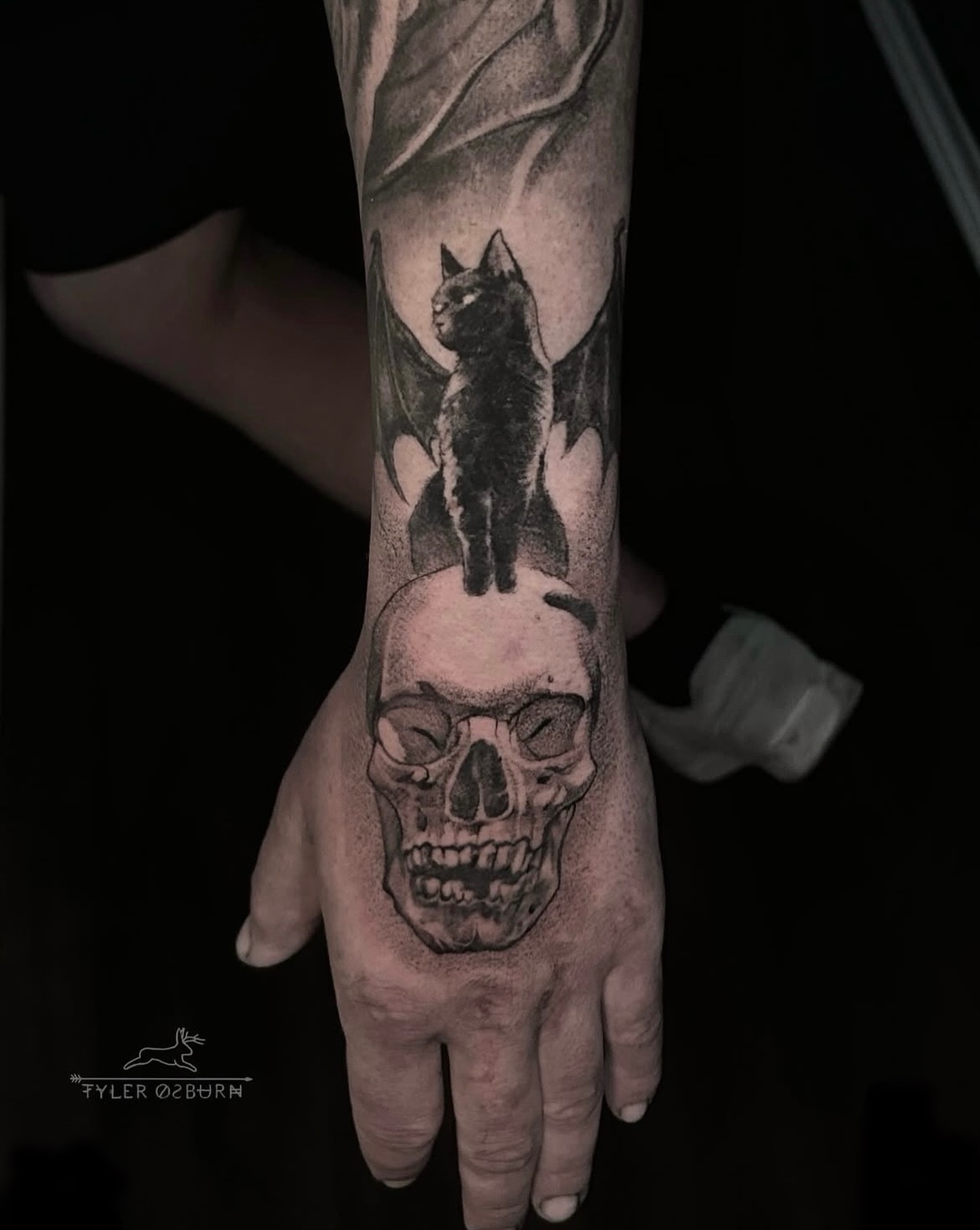 Cat and skull realism tattoo on the hand by Tyler Osburn
