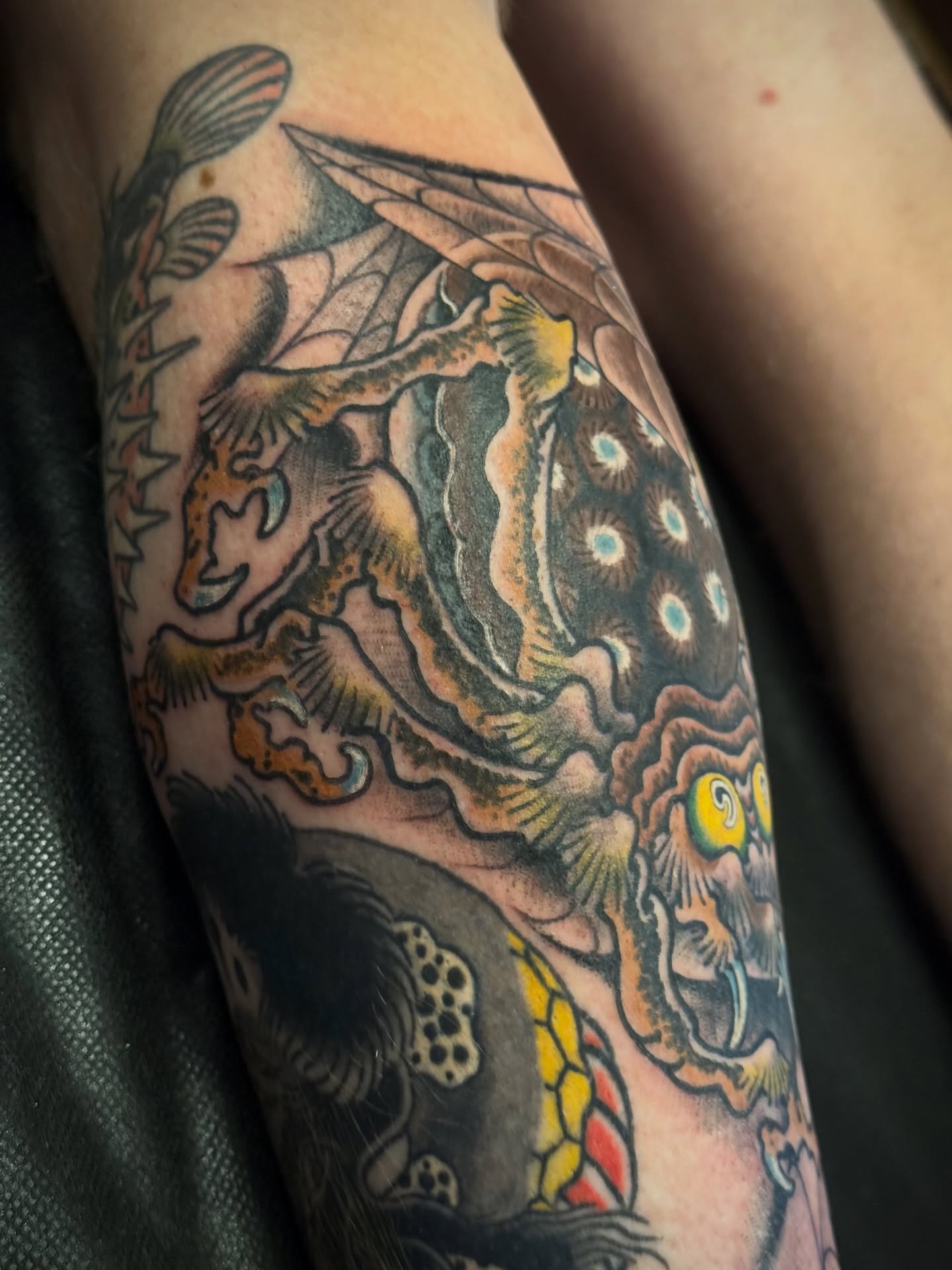 Fish and underwater scene American traditional tattoo on the forearm by Candi Kinyōbi
