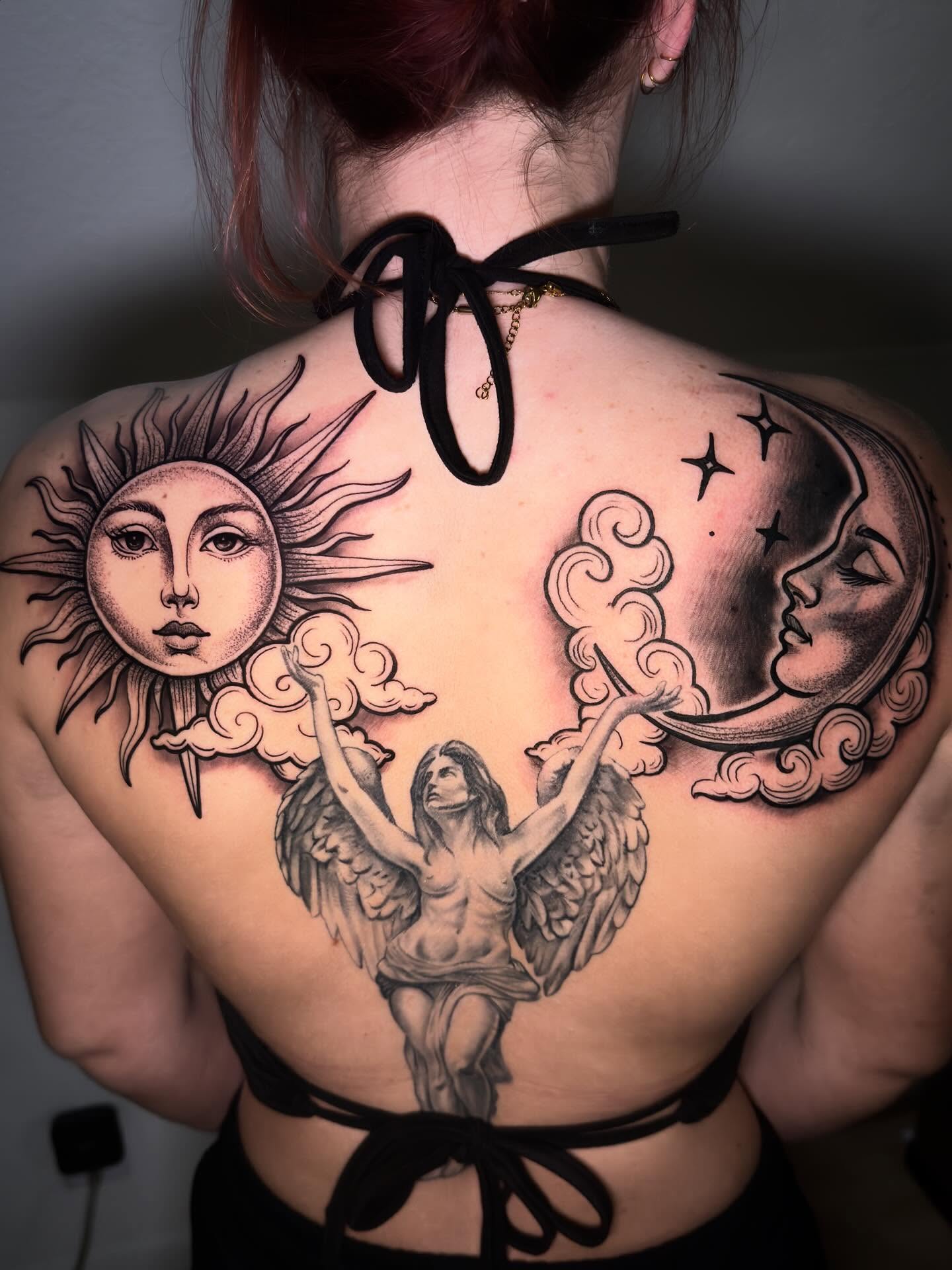 Sun, moon, angel realism tattoo on the back by Eric Zuluaga