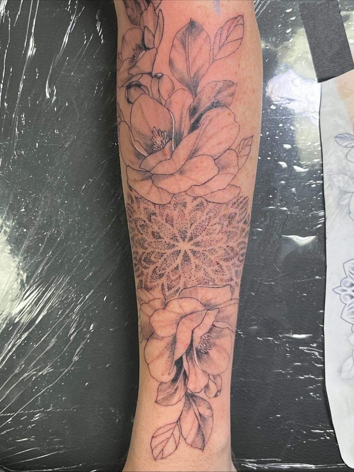 Floral mandala geometric tattoo on the forearm by Deville Pinson