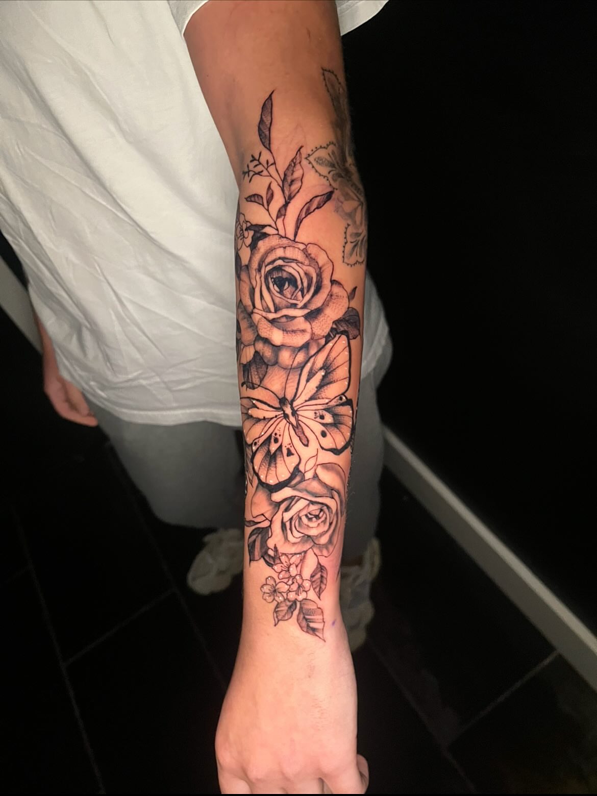 Roses and butterfly realism tattoo on the forearm by Deville Pinson