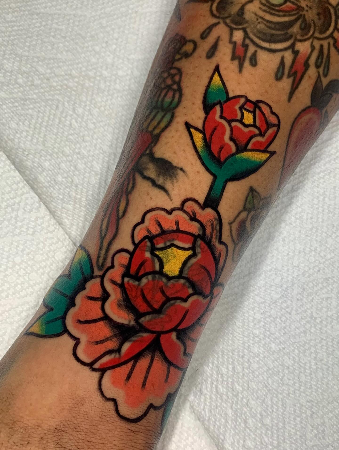 Peony flowers American traditional tattoo on the forearm by Shawn VanKirk