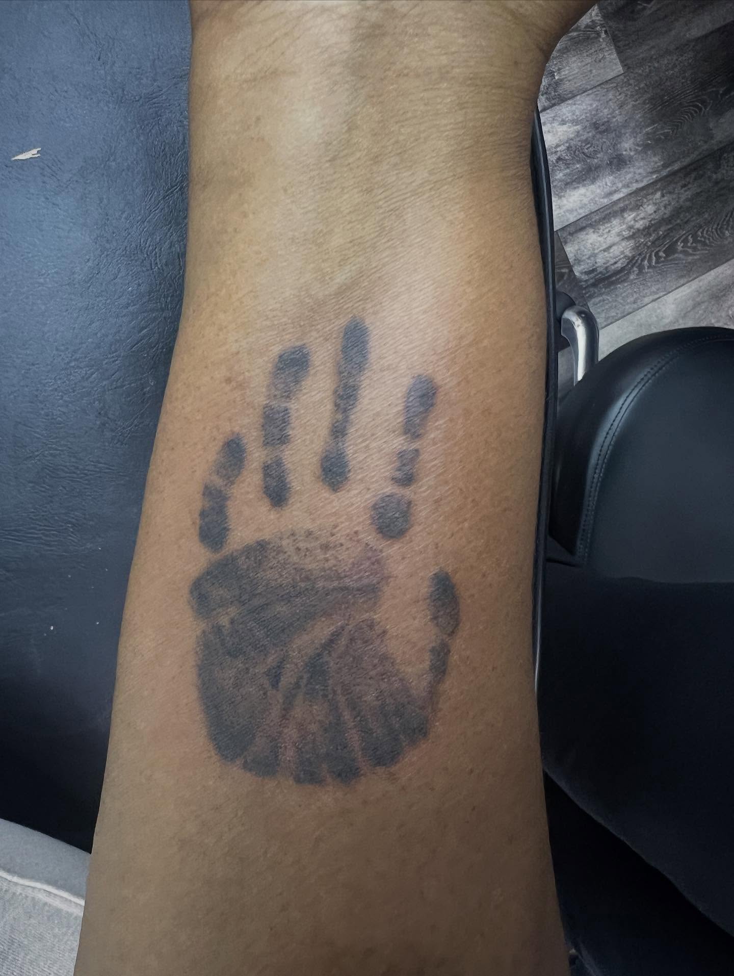 Handprint black and grey tattoo on the forearm by Monii Arreola