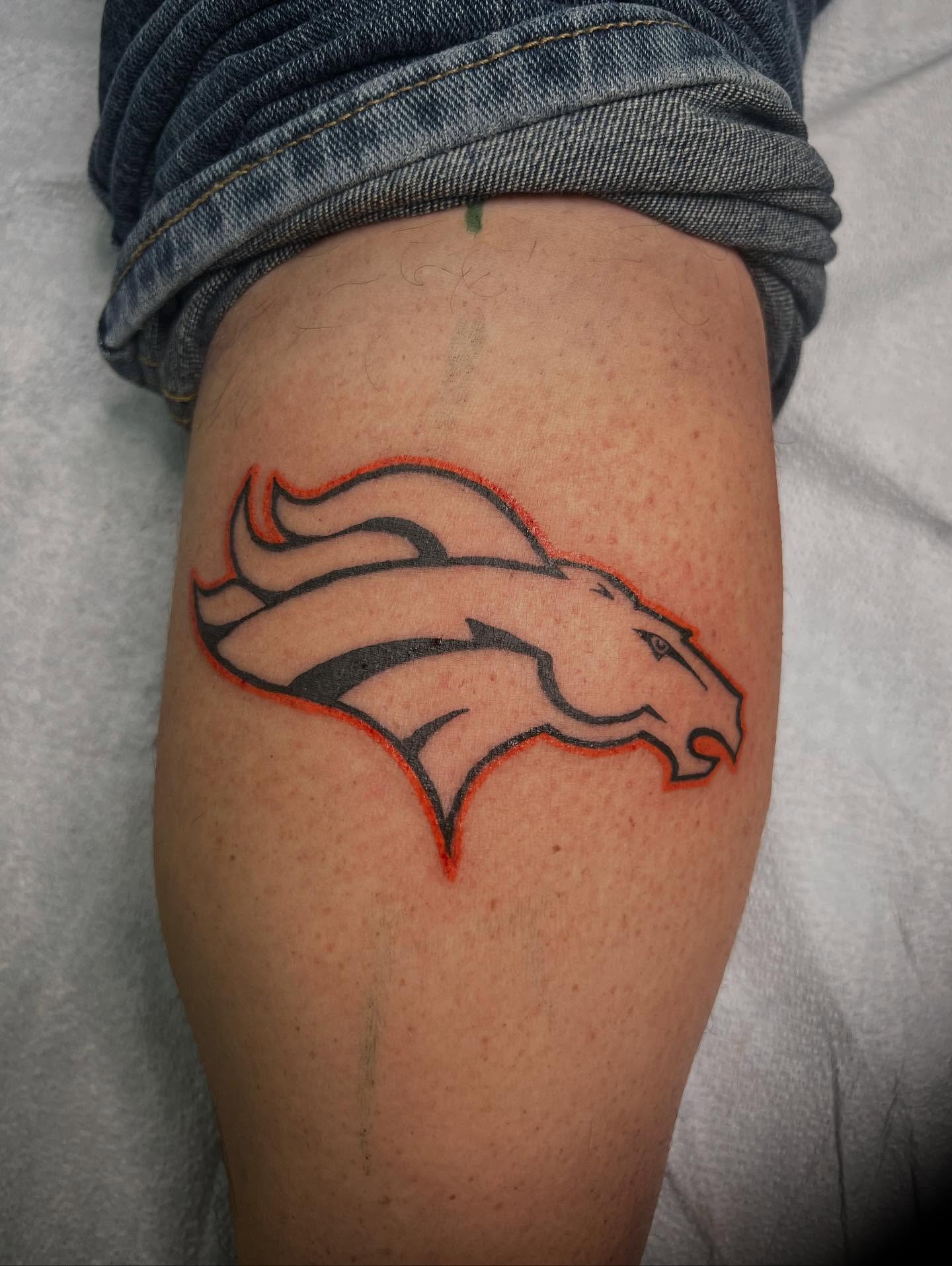 Broncos logo American traditional tattoo on the thigh by Monii Arreola