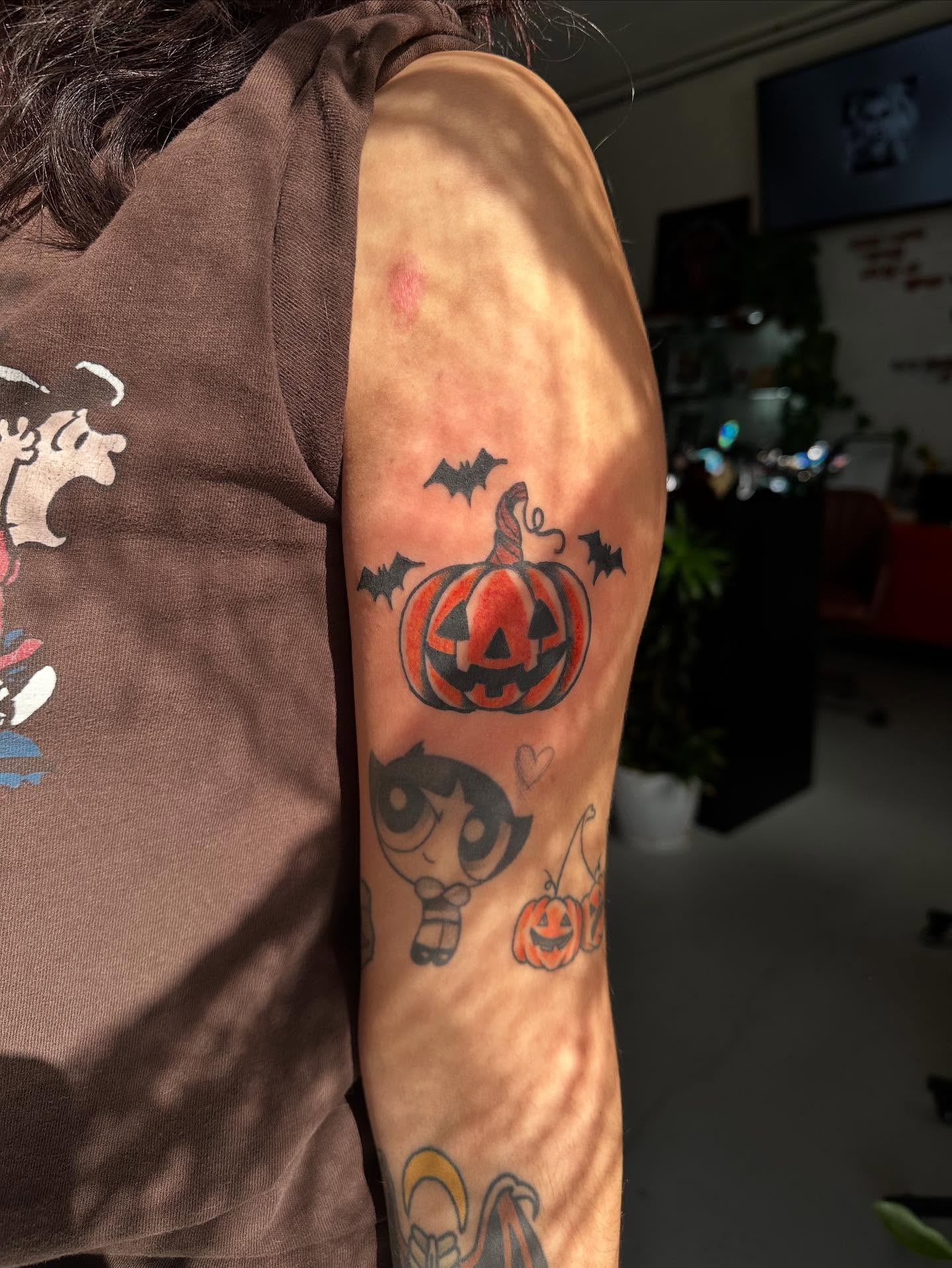 Pumpkin and bats American traditional tattoo on the forearm by HannaH