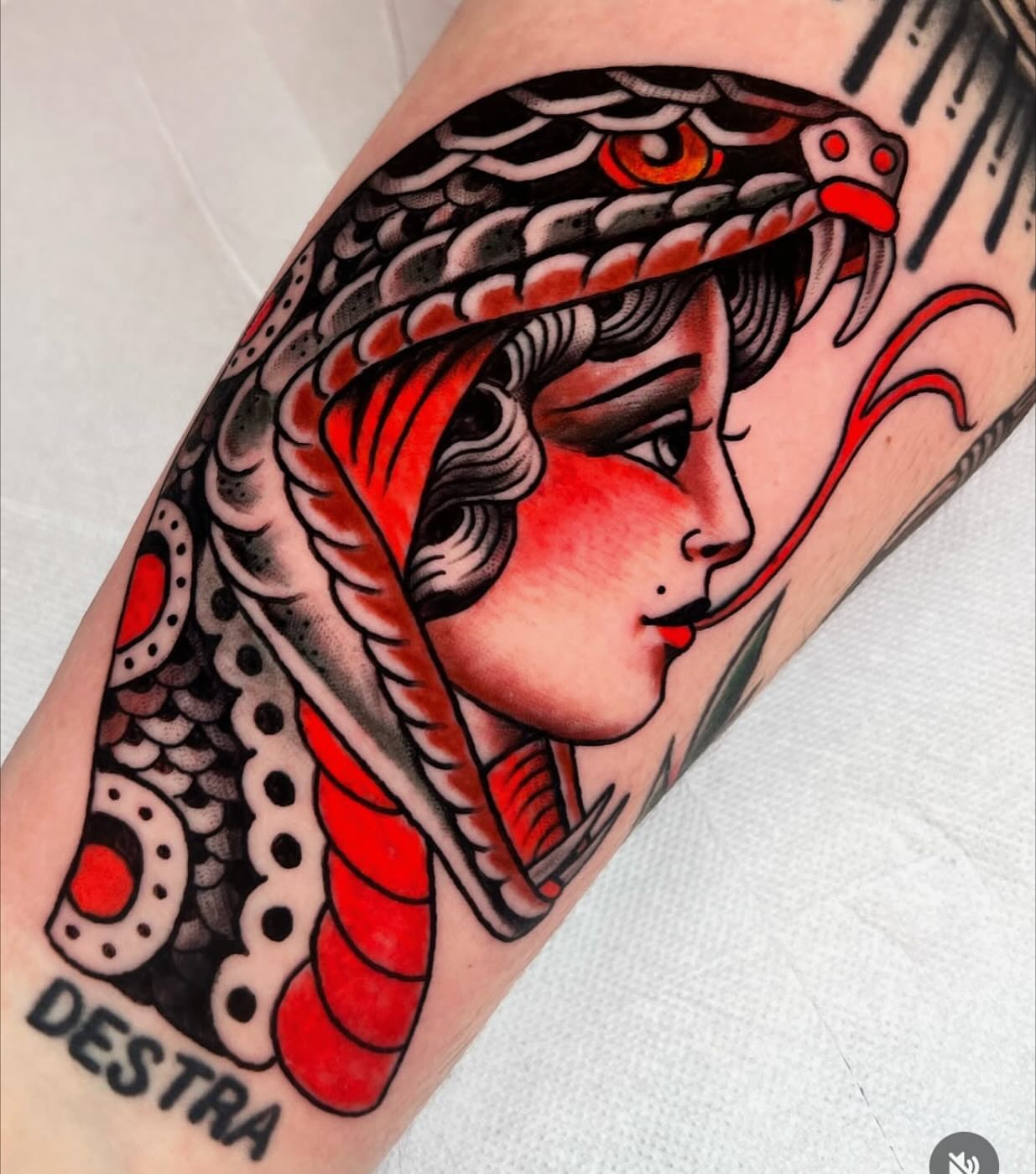 Woman with snake American traditional tattoo on the forearm by Graham Edward Vogel
