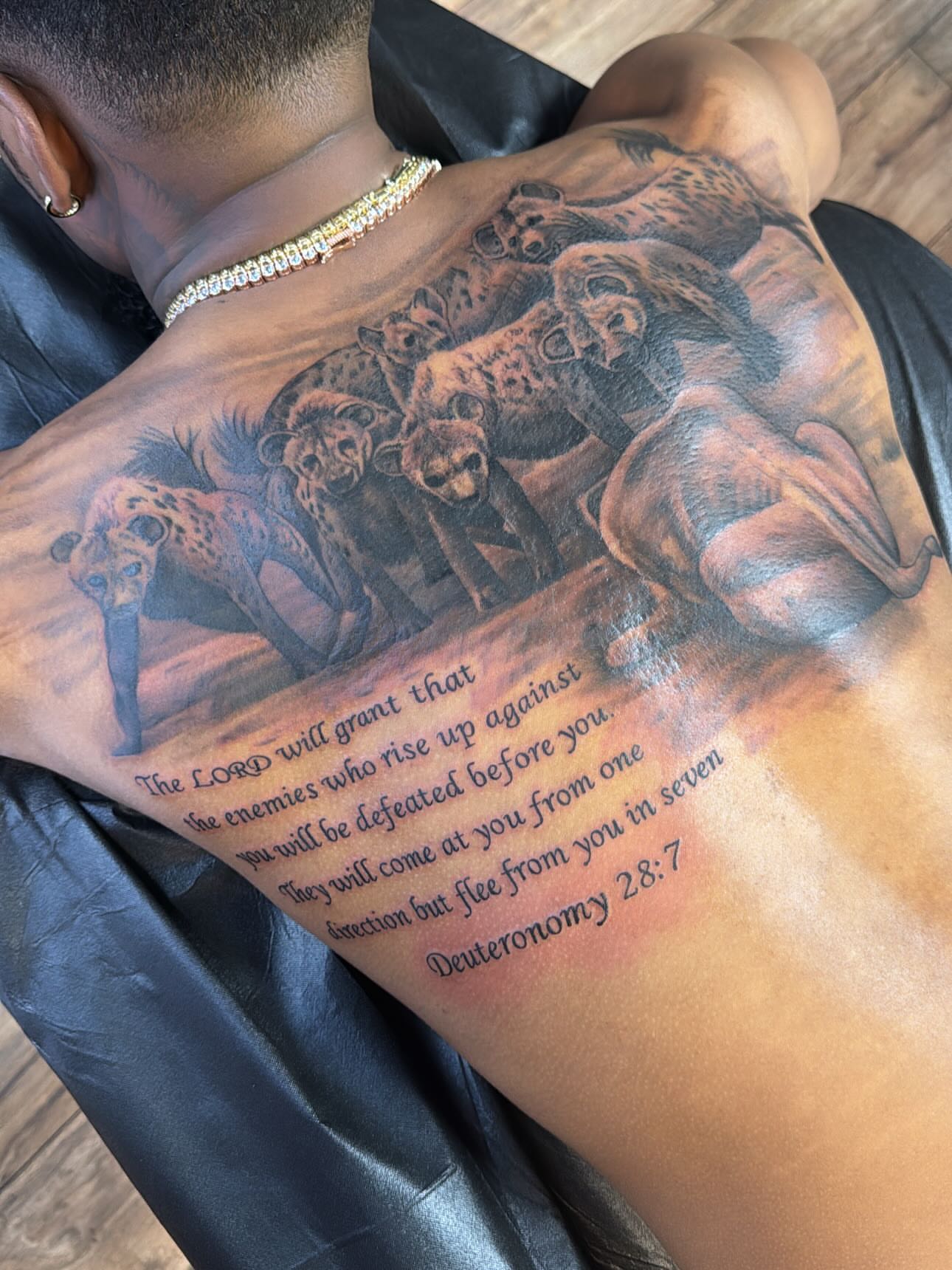 Cheetahs and biblical verse realism tattoo on the back by Cedric Fleming