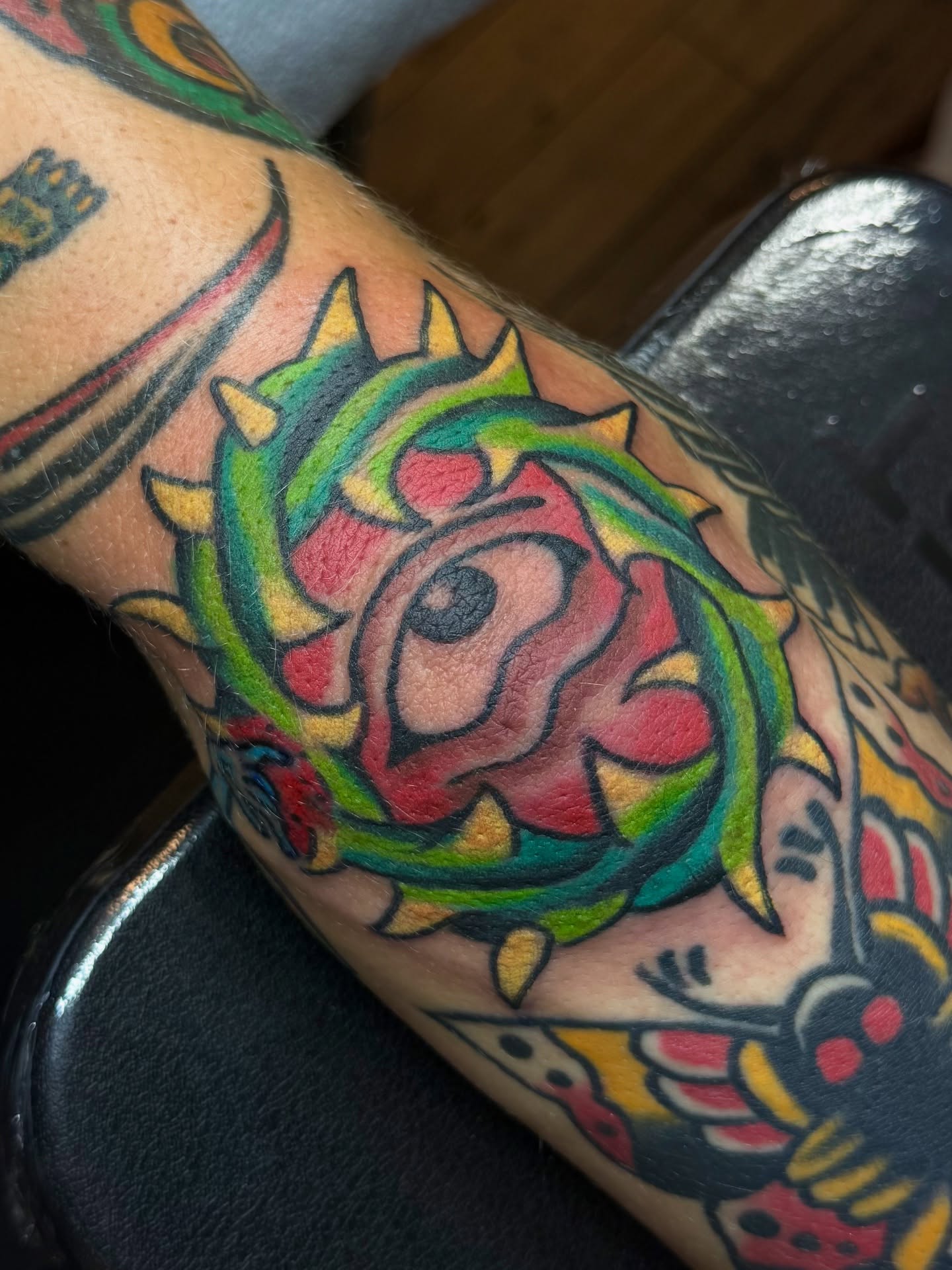 Rose American traditional tattoo on the forearm by Zac Clark