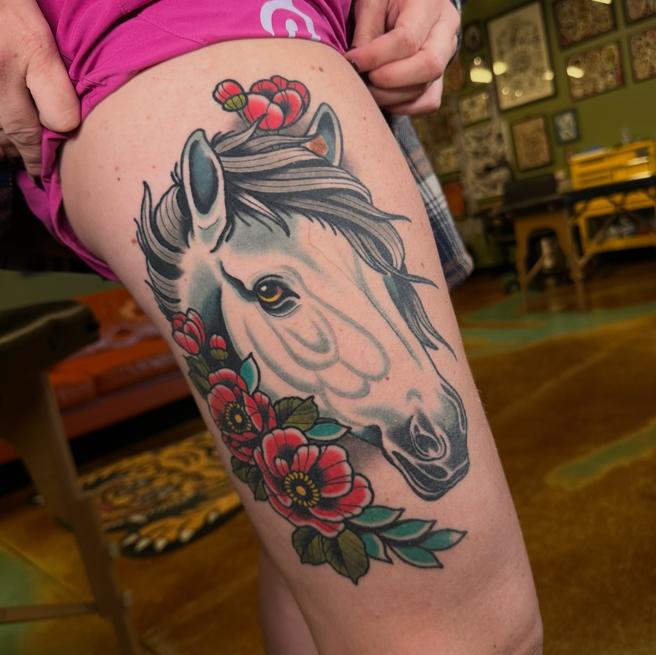 Horse and flowers American traditional tattoo on the thigh by Schyler Ames, Canal Fulton, Ohio