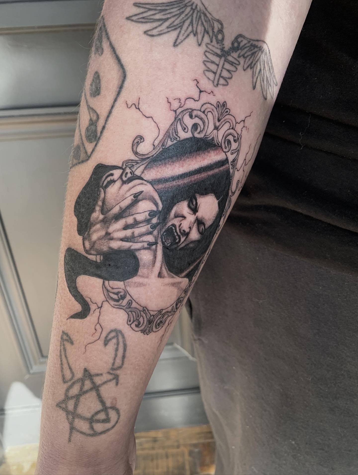 Couple embracing black and grey tattoo on the forearm by Jess, Midvale, Utah