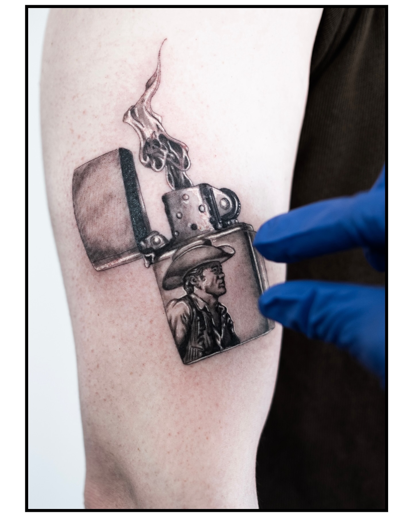Lighter with cowboy realism tattoo on the forearm by Ross Clark Tattoos
