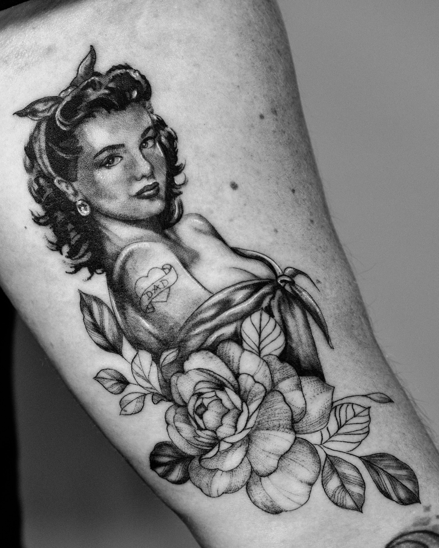 Pin-up girl American traditional tattoo on the forearm by Ross Clark Tattoos