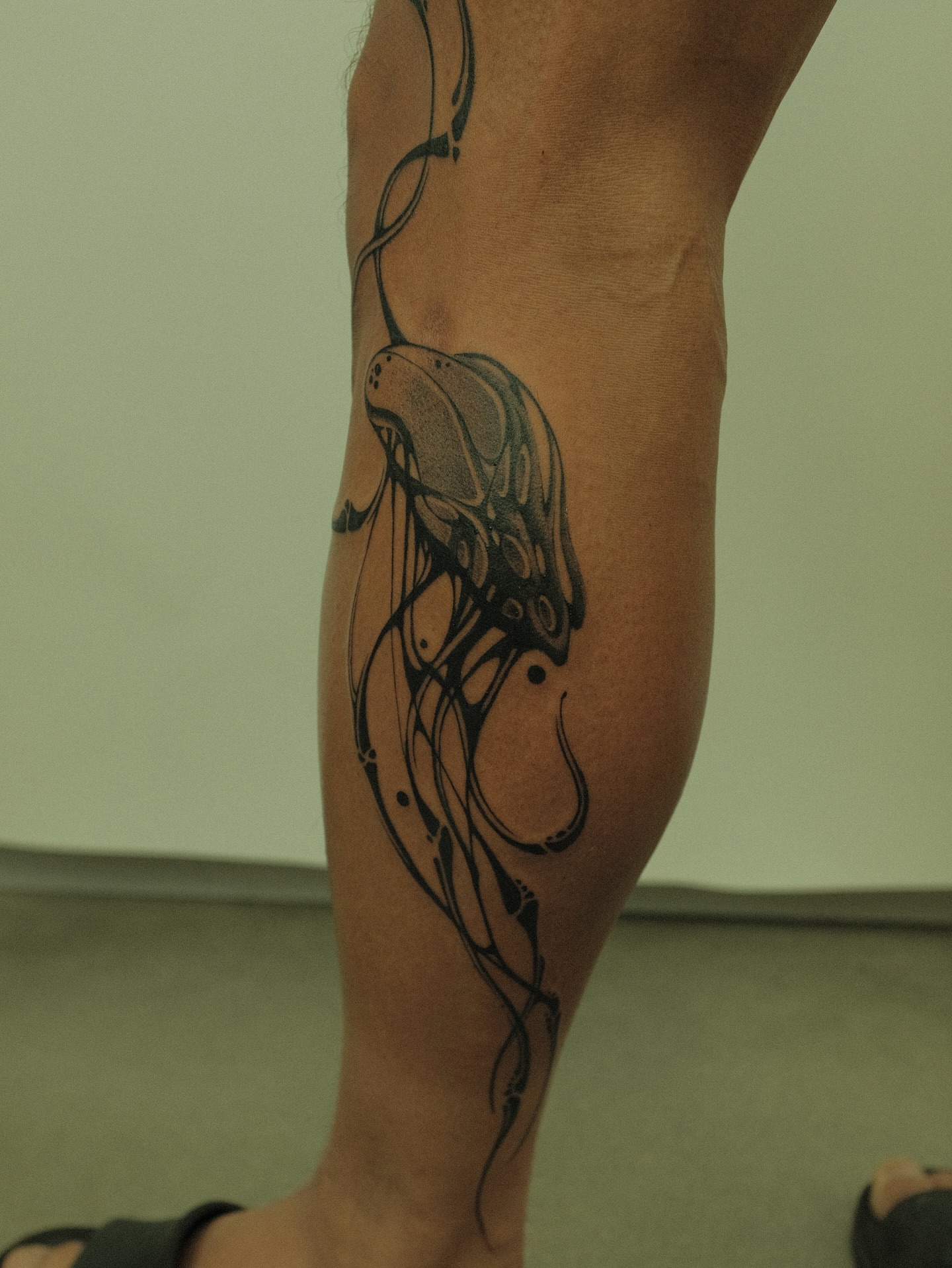 Jellyfish black and grey tattoo on the forearm by Xiao Lun