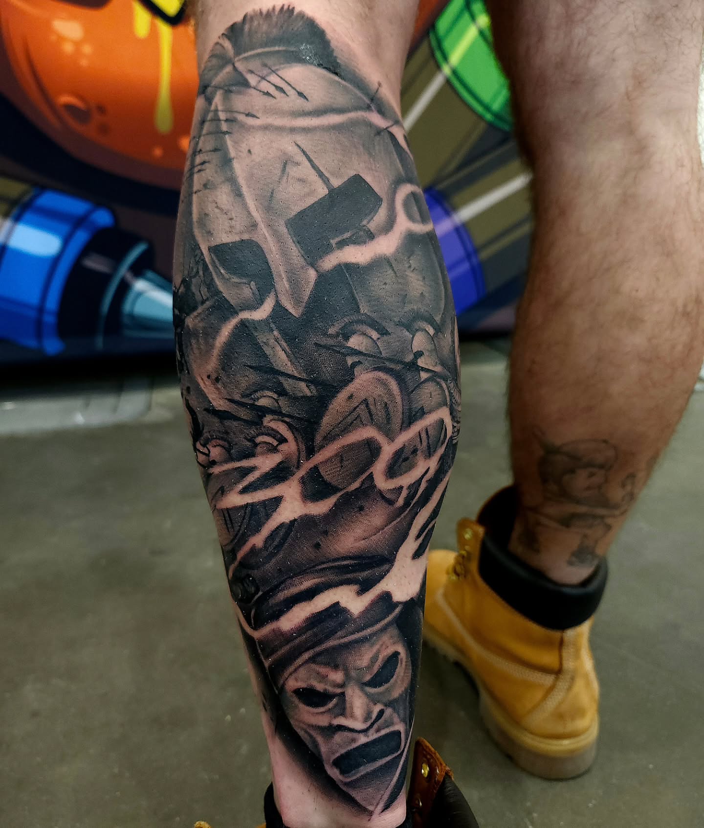 Warrior helmet and sword realism tattoo on the forearm by Chris Wodarski