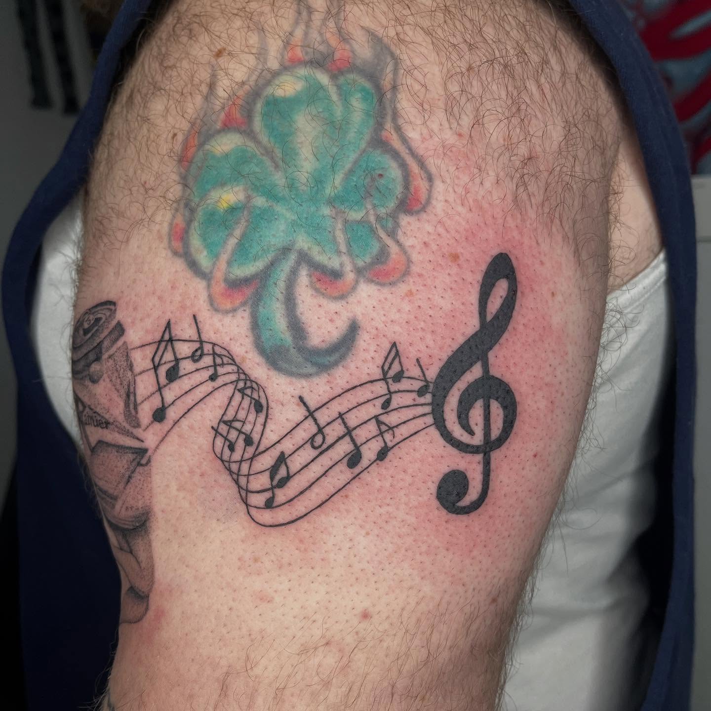 Clover and music notes American traditional tattoo on the thigh by Gabbie